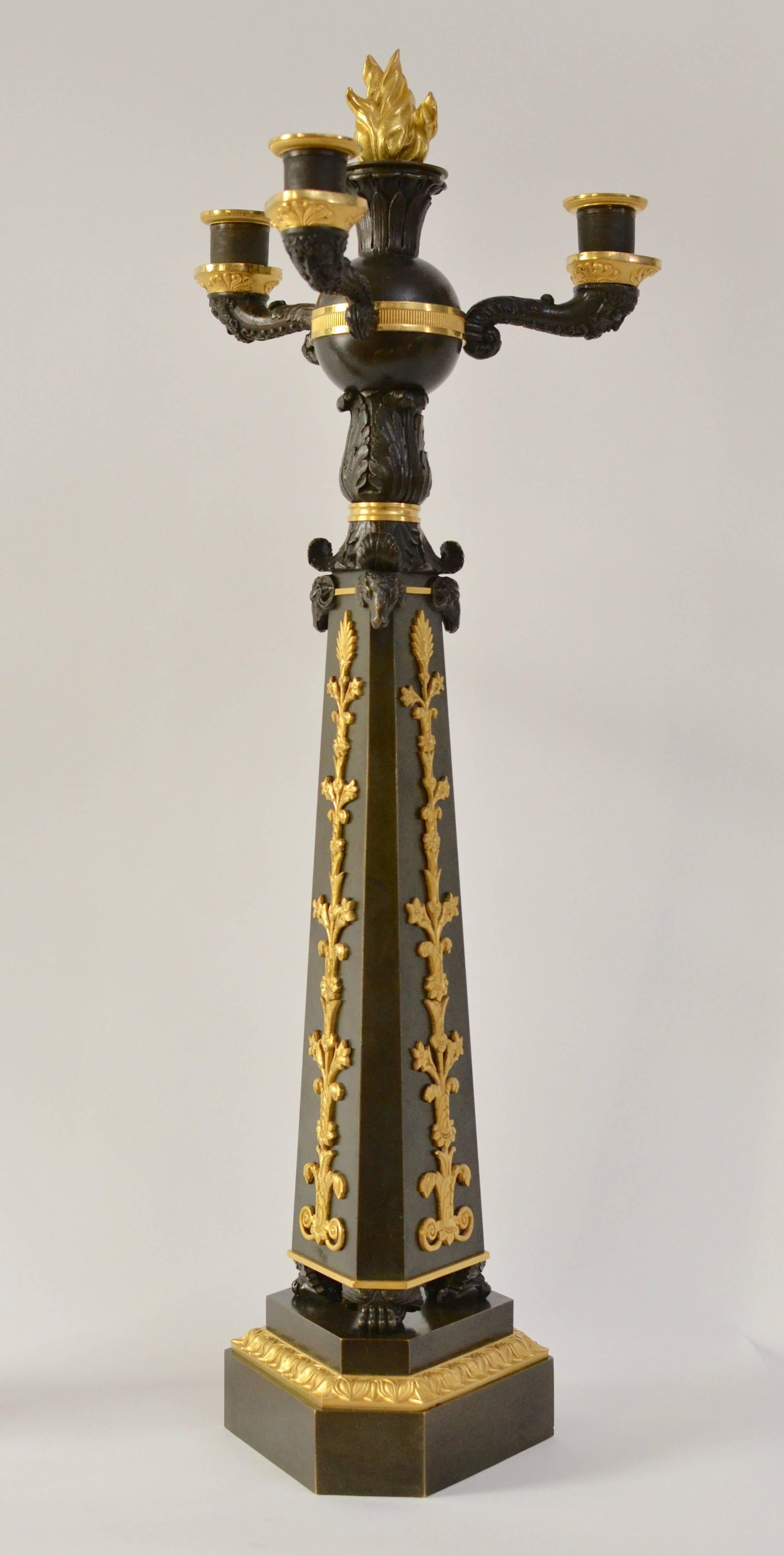 A pair of Empire gilt and patinated bronze candelabra, circa 1825.