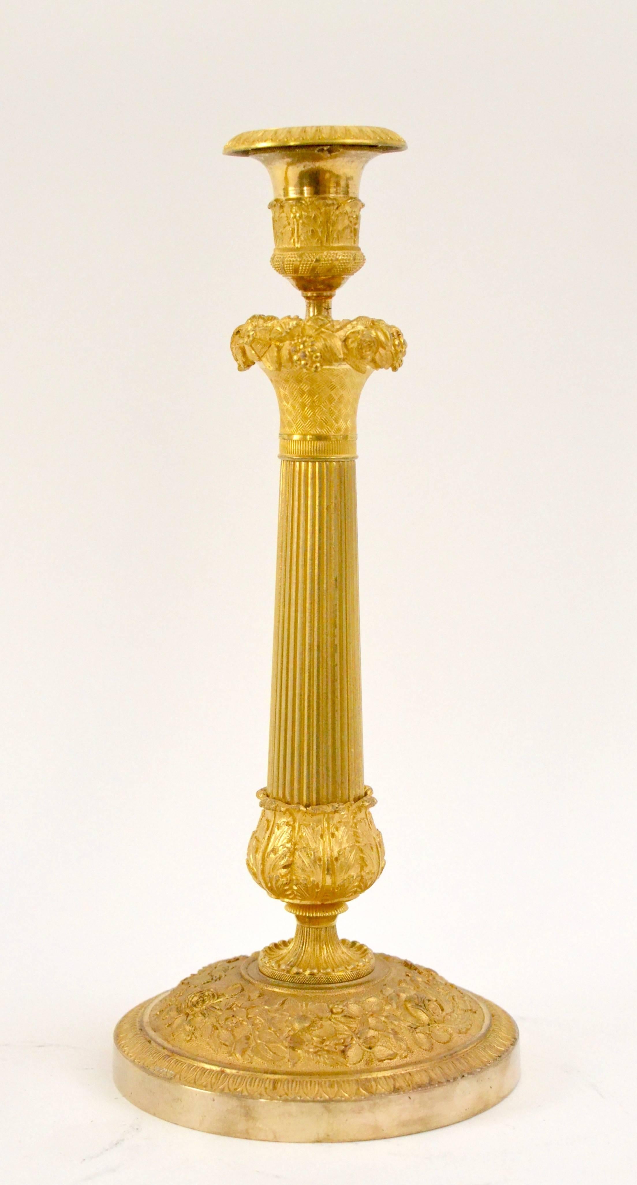 A pair of gilt bronze Empire candlesticks, early 19th century.