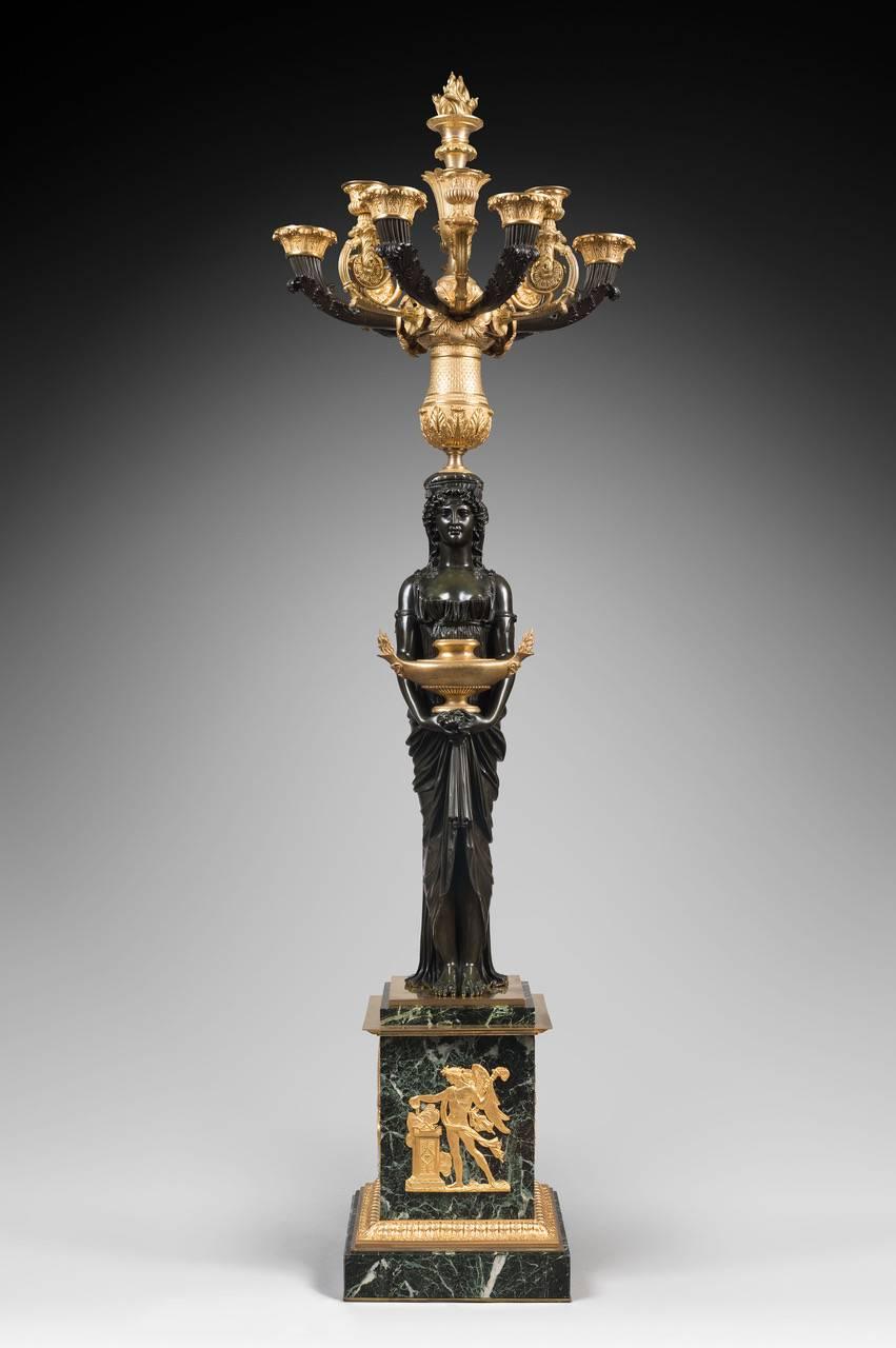 A very large and impressive pair of patinated and gilt-bronze candelabra signed THOMIRE A PARIS with vestals holding the candelabra arms, French, circa 1830. 

Pierre-Philippe Thomire (1751–1843) a French sculptor, was the most prominent bronzier,