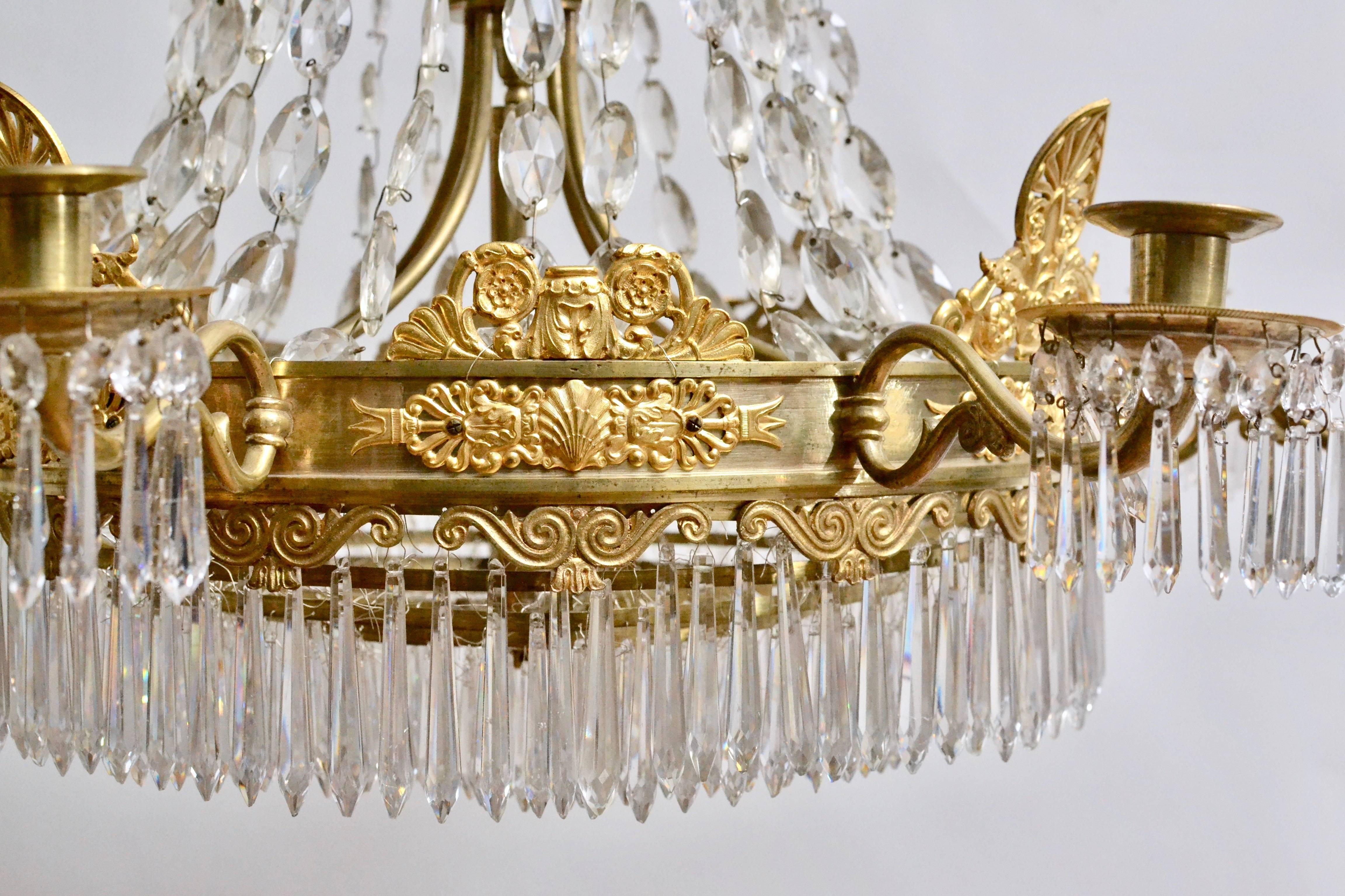 A French Empire gilt bronze and crystal chandelier, circa 1825. Signed SUIREAU A PARIS.