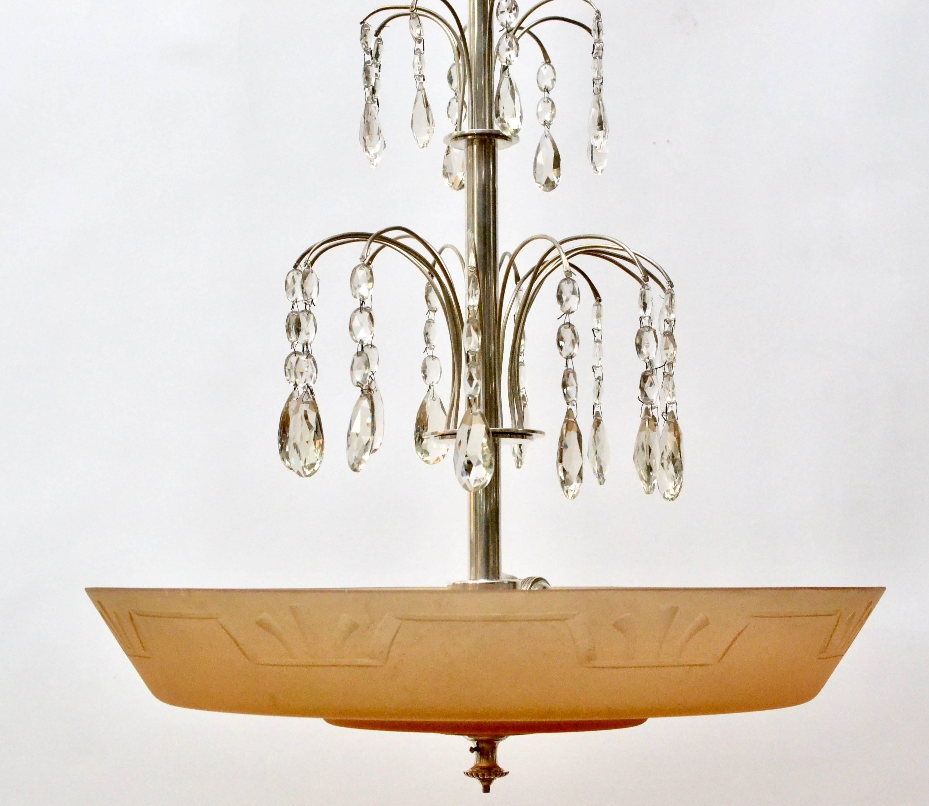 A Swedish glass and silvered bronze Art Deco ceiling lamp, circa 1930. The colored glass bottom attributed to Simon Gate (1883-1945).