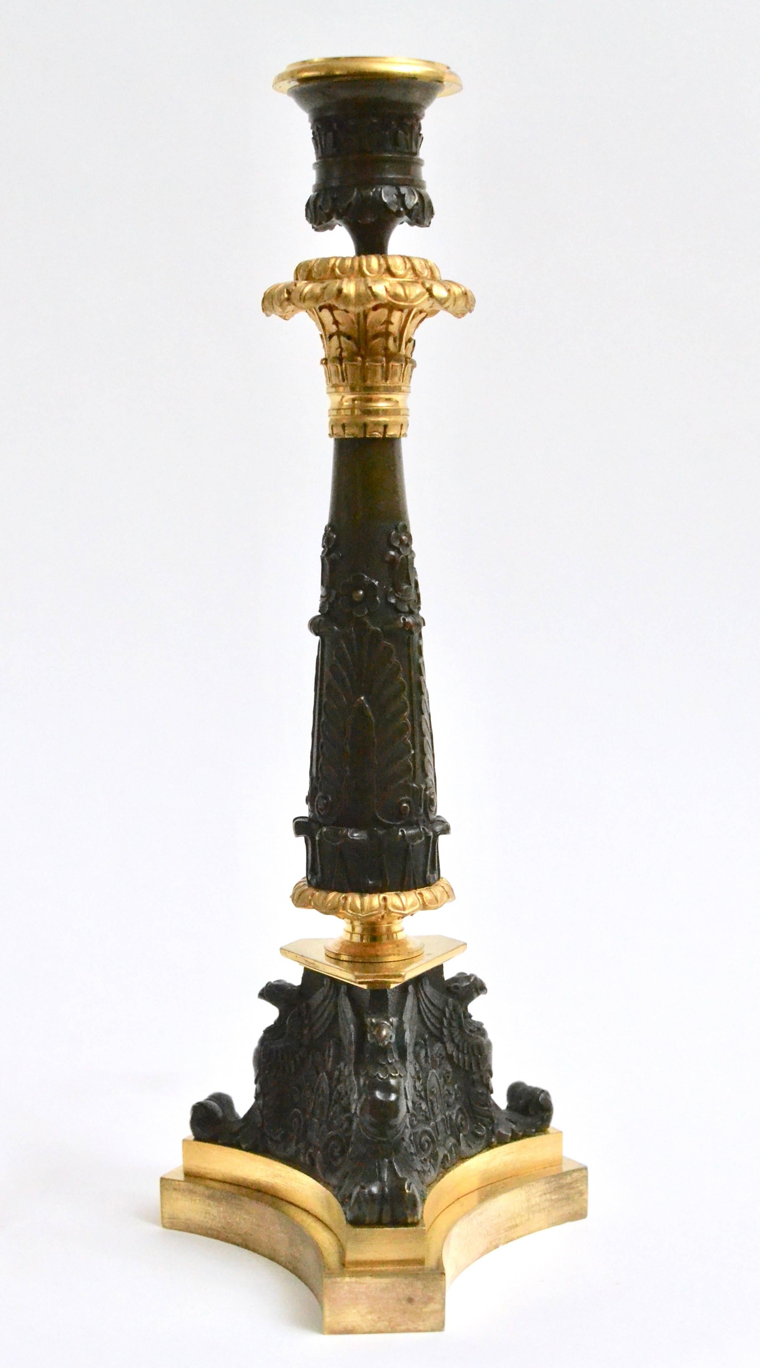 A pair of Empire gilt bronze candlesticks, circa 1825.
