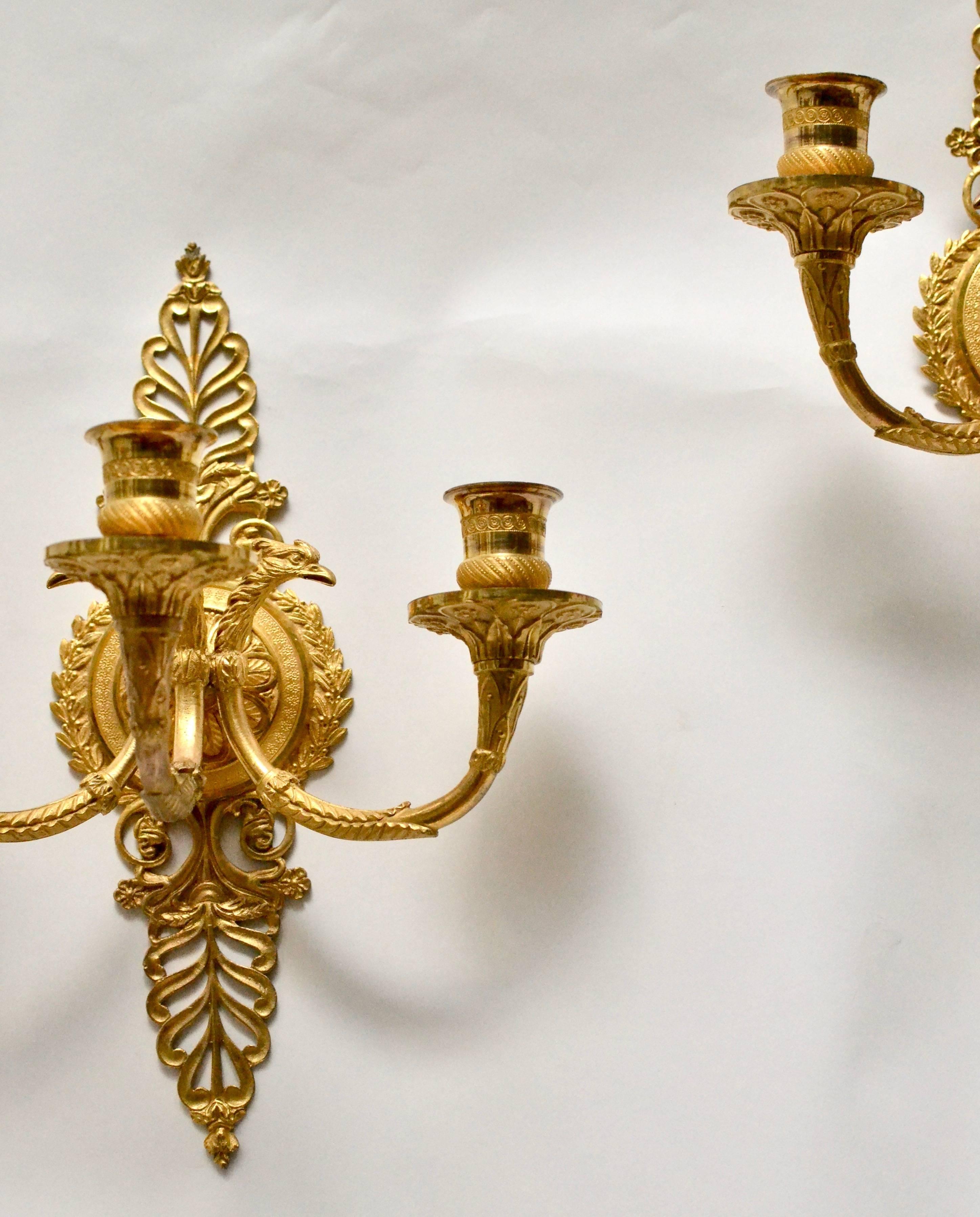 A pair of gilt bronze empire wall appliqués, early 19th century.