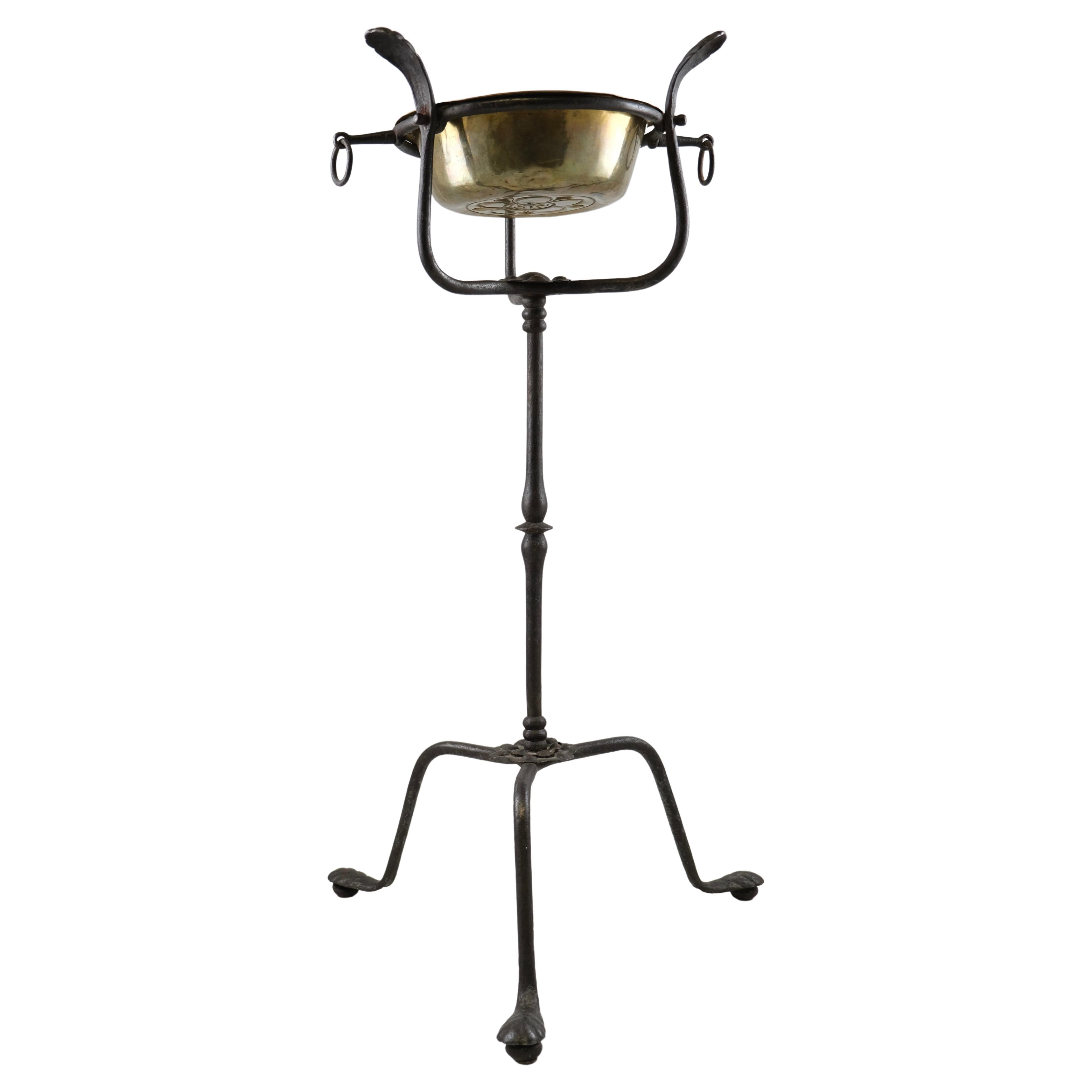 A wrought Iron Stand with a brass bowl , 17th Century For Sale