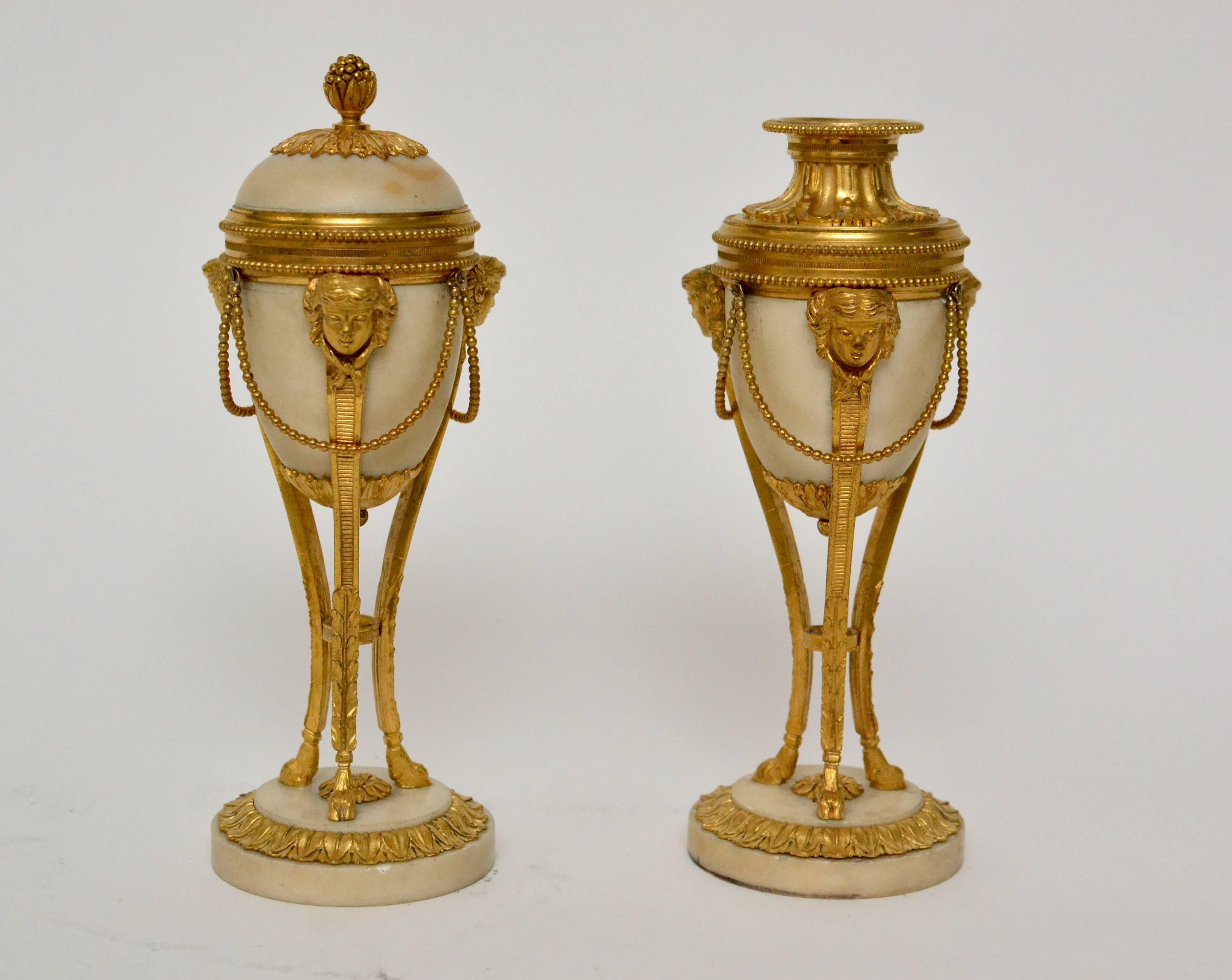 Pair of gilt bronze and white marble Louis XVI cassolettes, late 18th century.