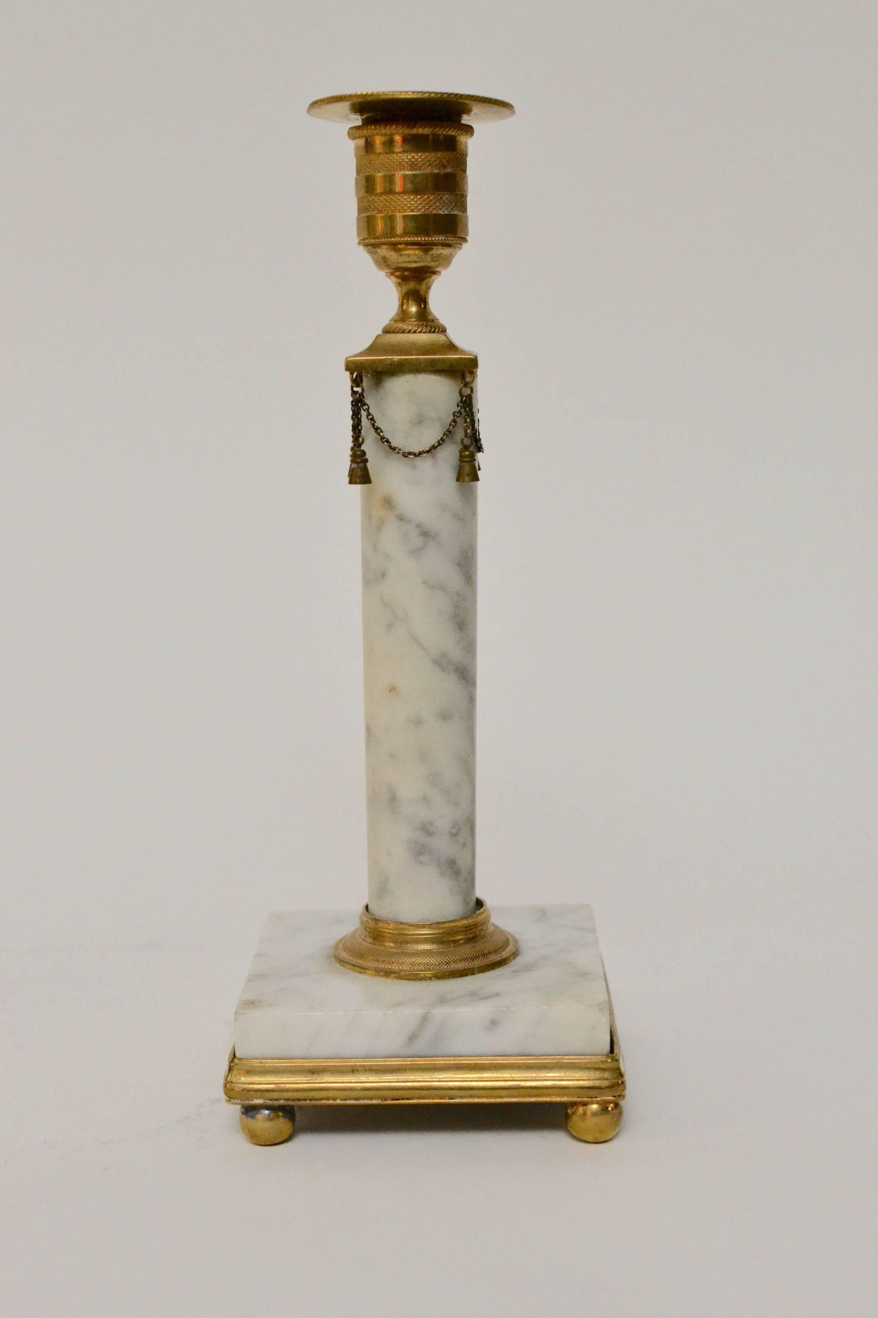 Pair of Gustavian gilt bronze and white marble candlesticks, late 18th century. 