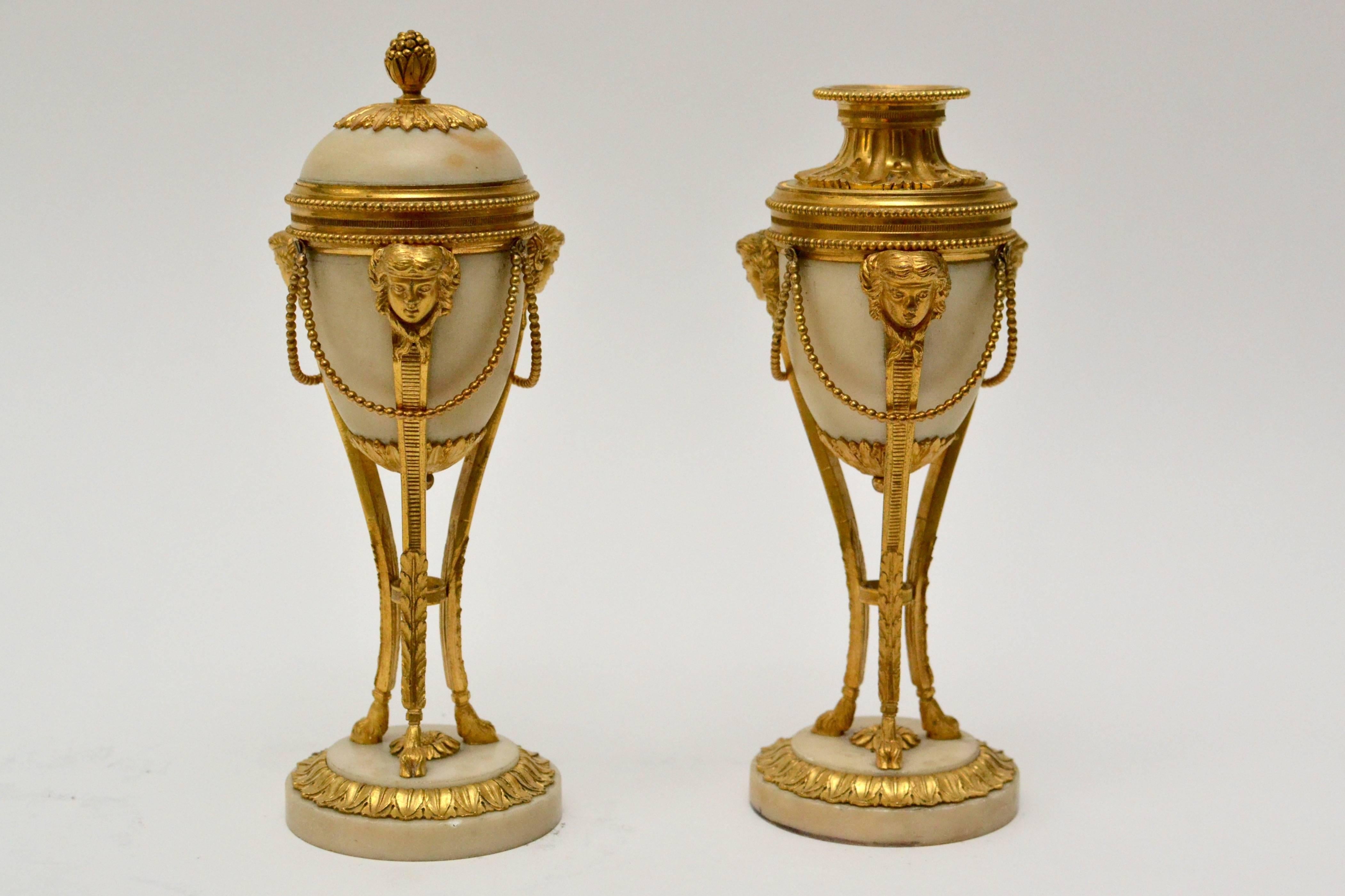 A pair of Louis XVI gilt bronze and white marble casolettes, late 18th century.