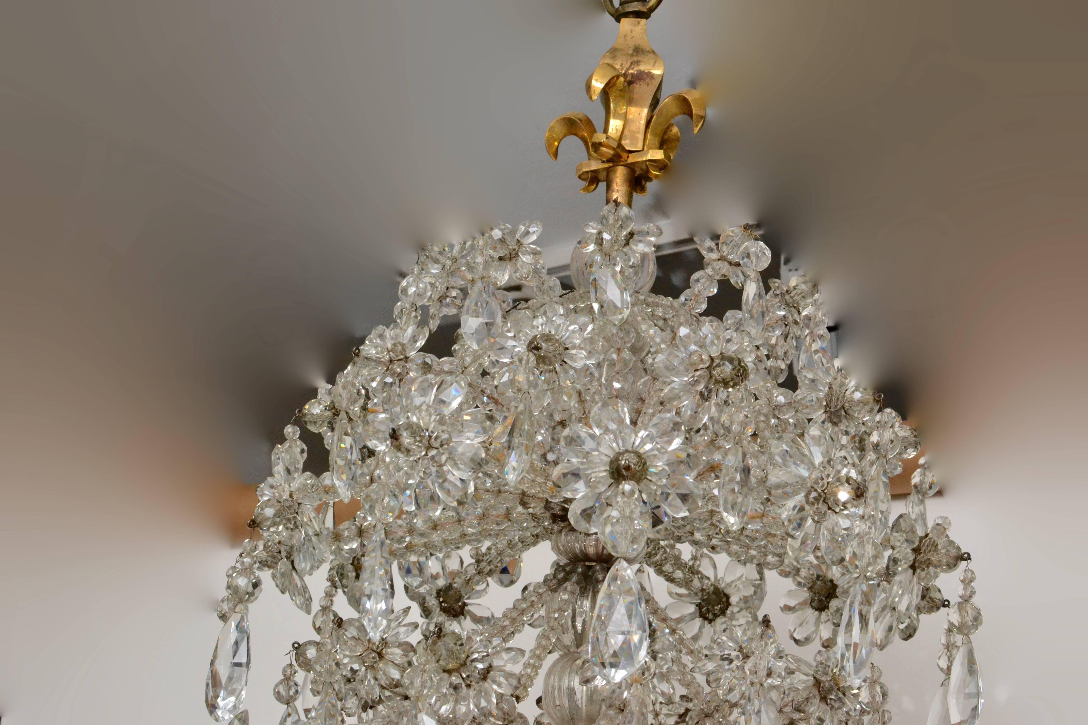 A very unusual crystal and gilt bronze chandelier of very Fine quality with no expensive saved in it’s making when made in Paris during the 19th century. It’s crowned with a double gilt bronze fleur-de-lis. The model is based on a French Louis XIV