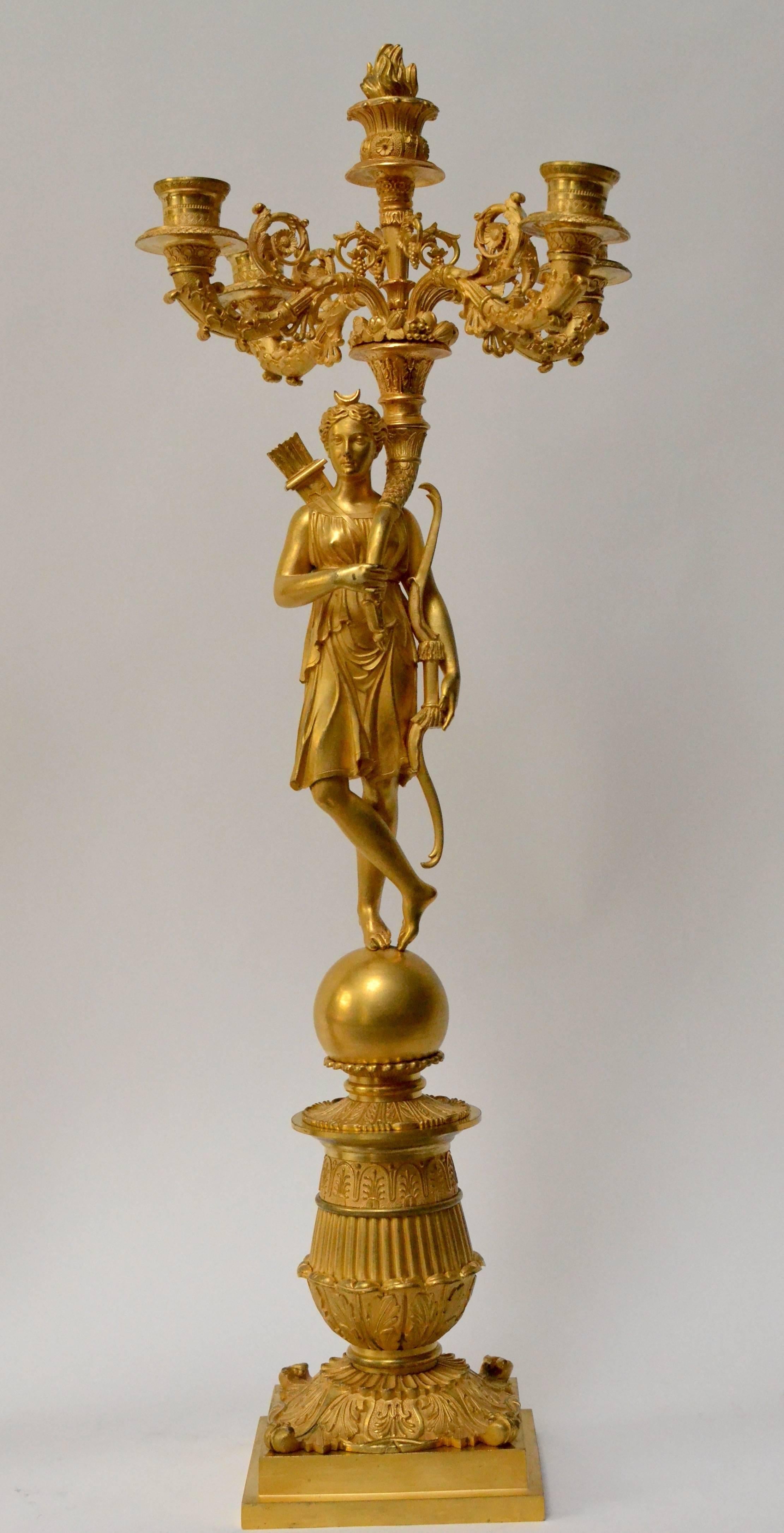 Pair of French gilt bronze and patinated Empire candelabra, circa 1825. The figures holding the candle branches are of Diana and Apollo.