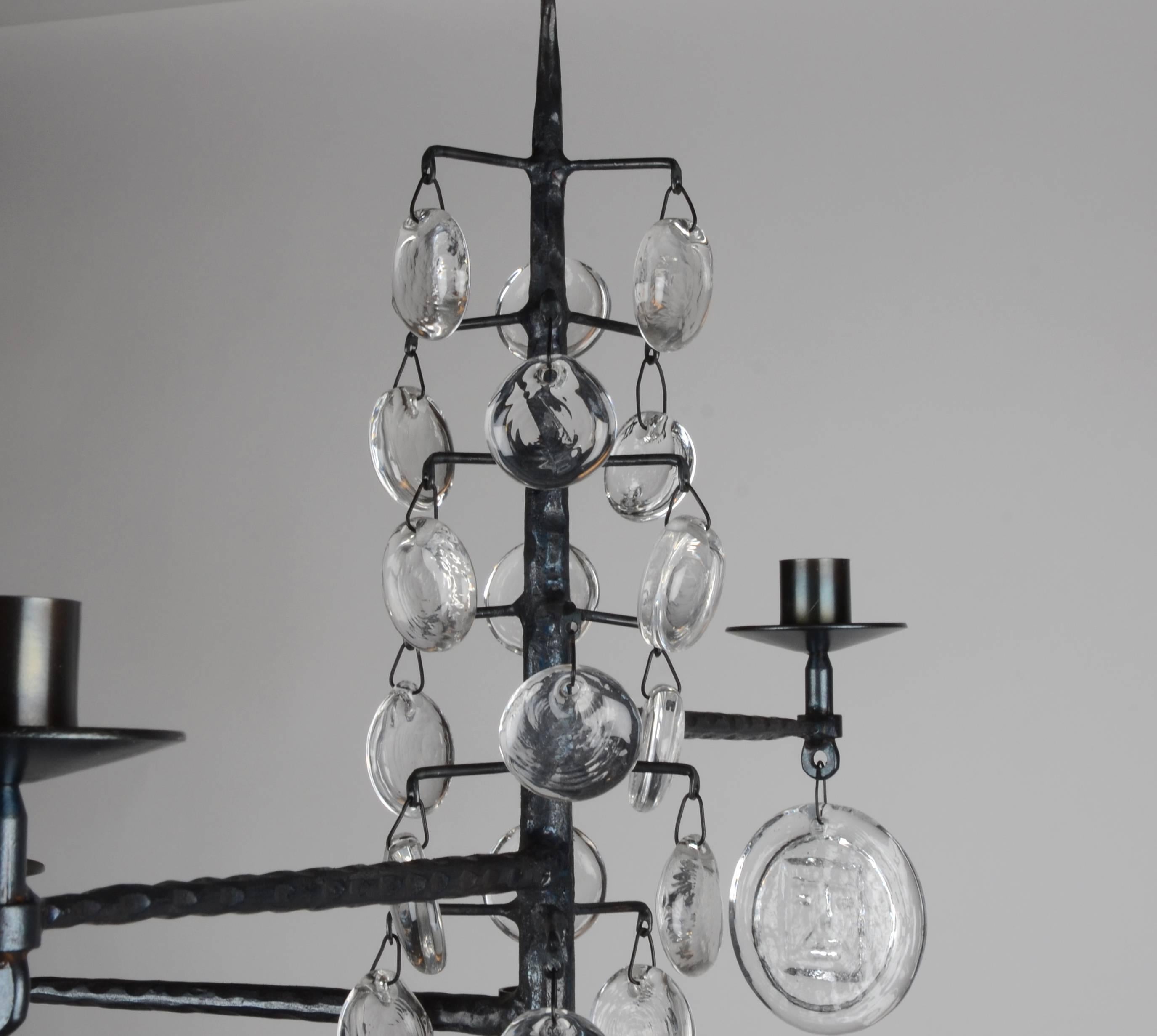 Twelve-armed chandelier in glass and cast-iron. Designed by Erik Höglund for Boda Smide.