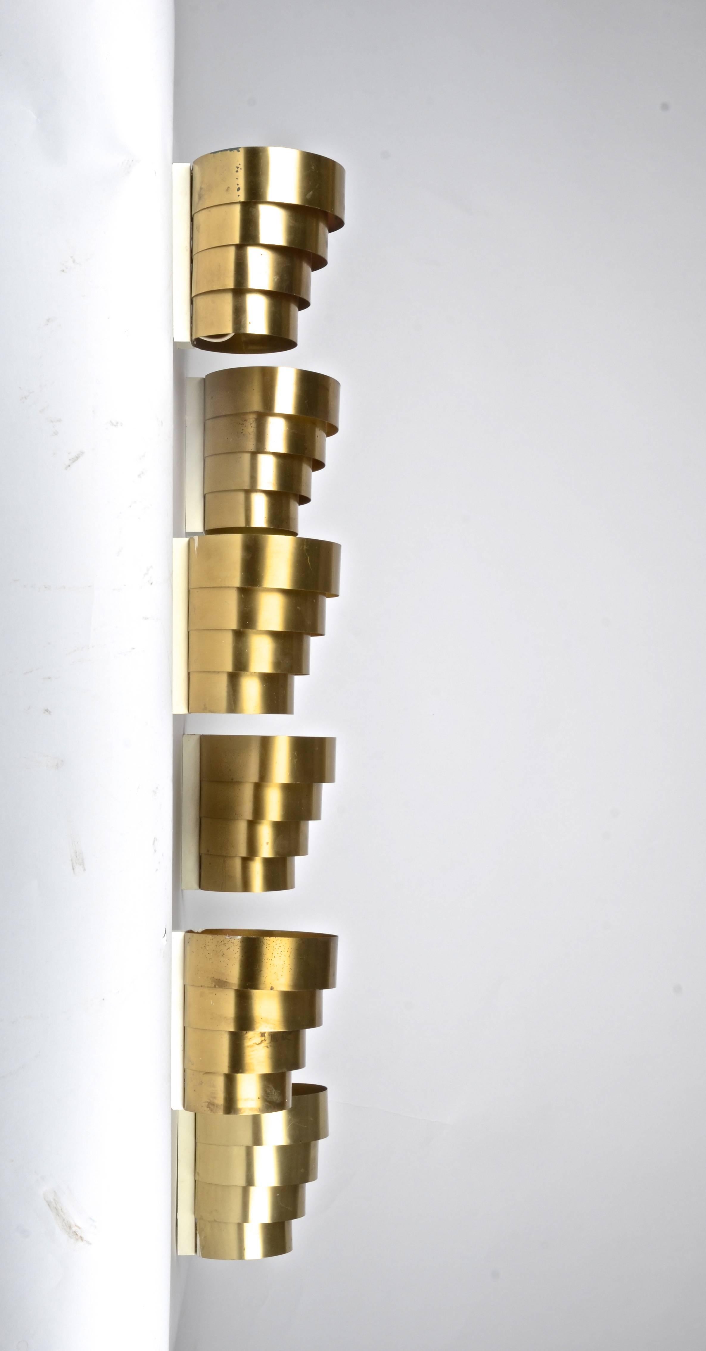Brass sconces by Hans-Agne Jakobsson for Markaryd, designed in the 1960s. Brass sheet, partly painted white.

Six are available. 