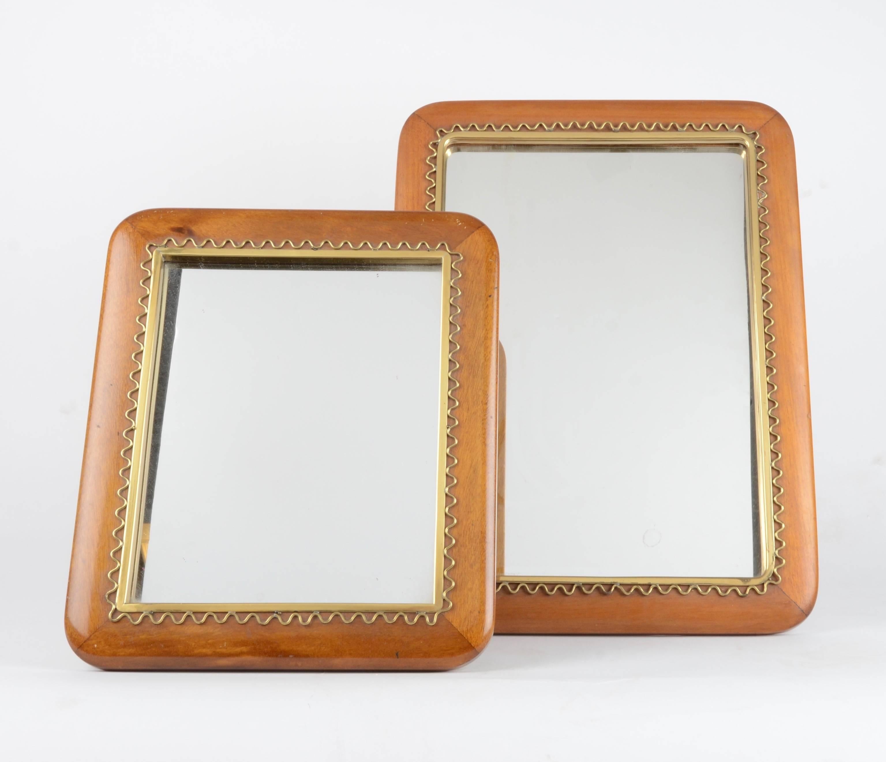 A pair of mirrors for table or wall in mahogany and brass. Designed by Josef Frank for Firma Svenskt Tenn, mid-1900s.