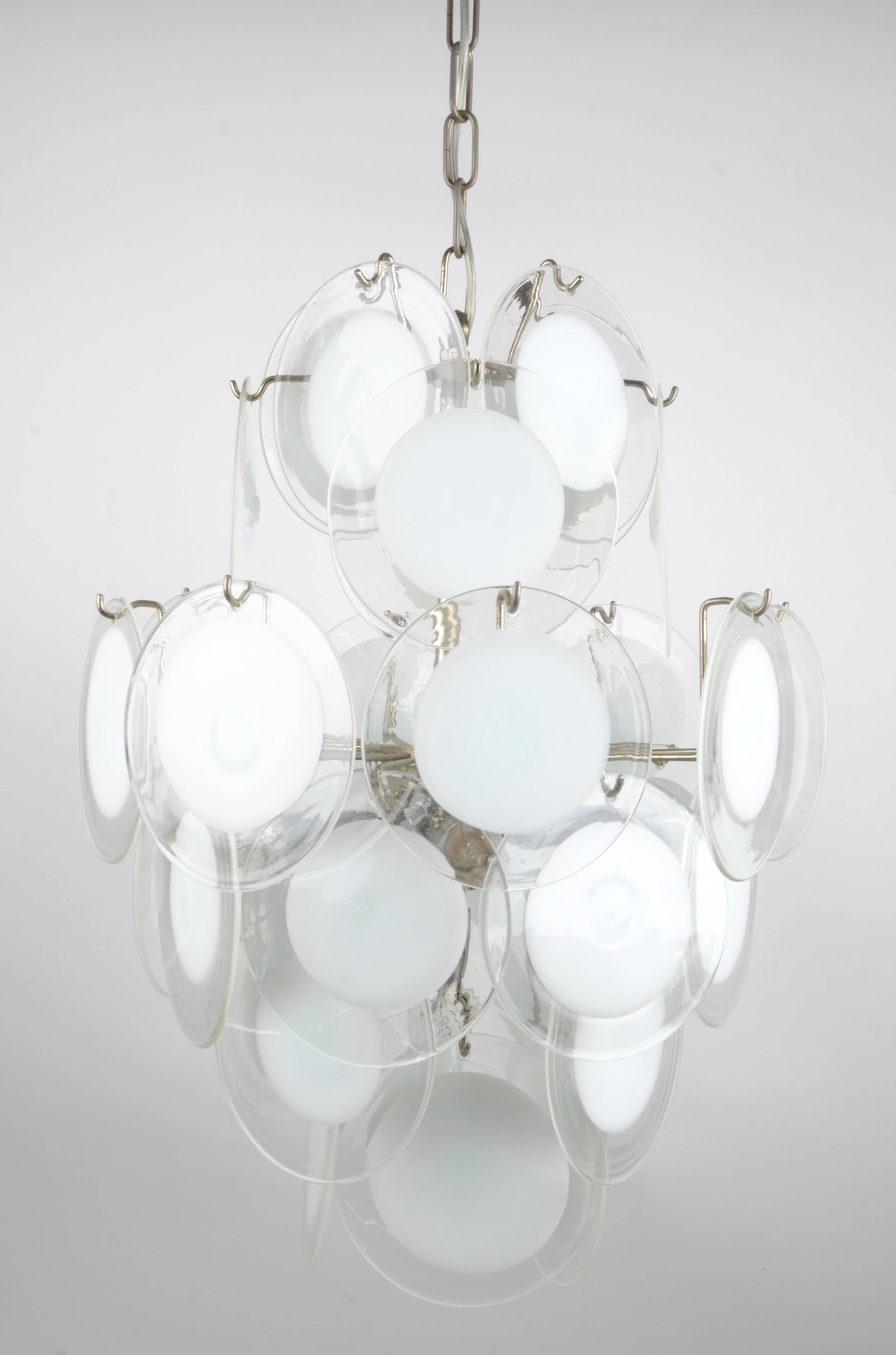 Chandelier with clear and white glass discs, made by Vistosi, Murino. Italy, 1970s.