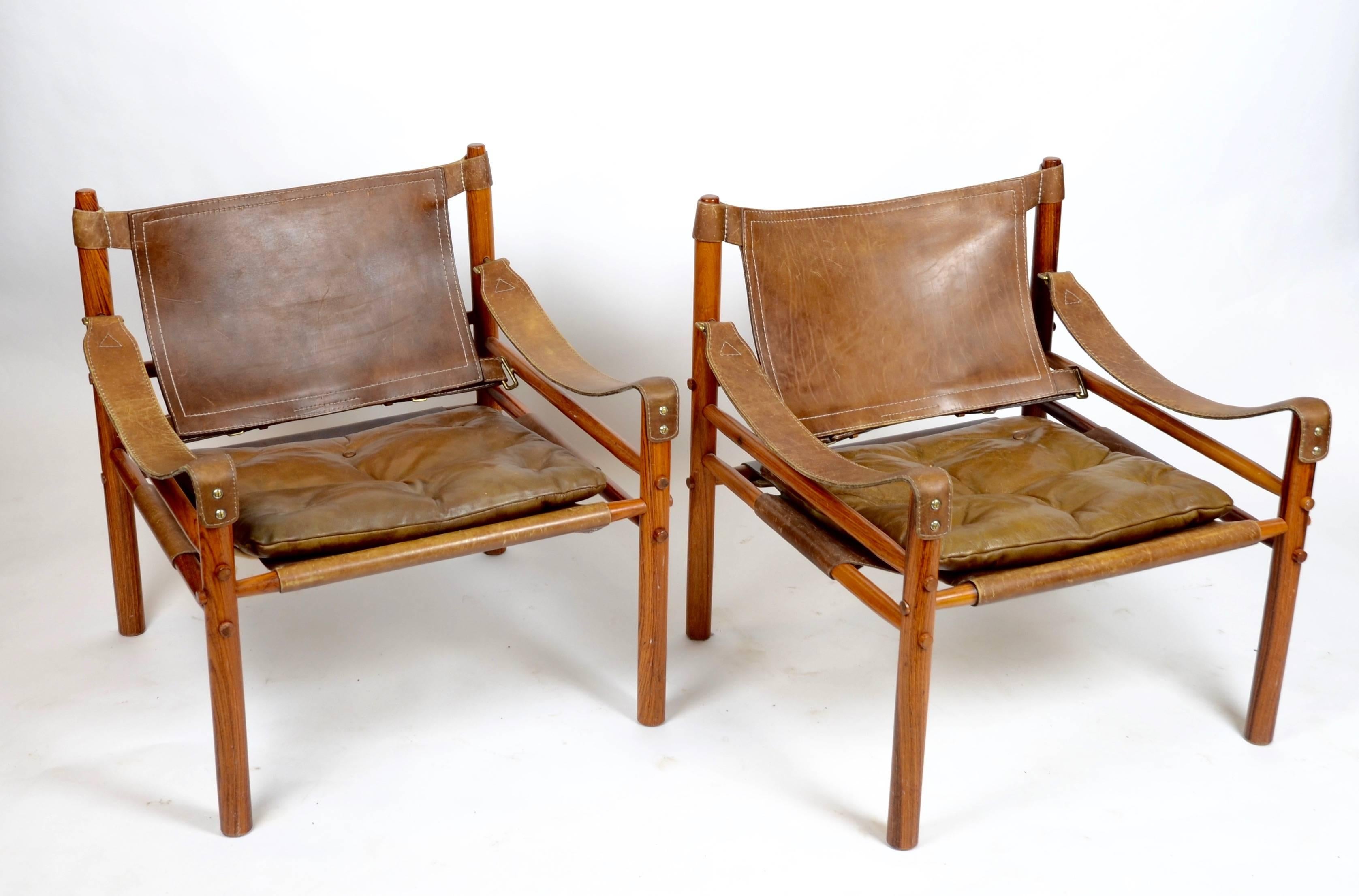 A pair of safari chairs, model Sirocco in rosewood and leather. Designed by Arne Norell, Sweden, 1960s.