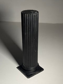 Neoclassical column in black plaster