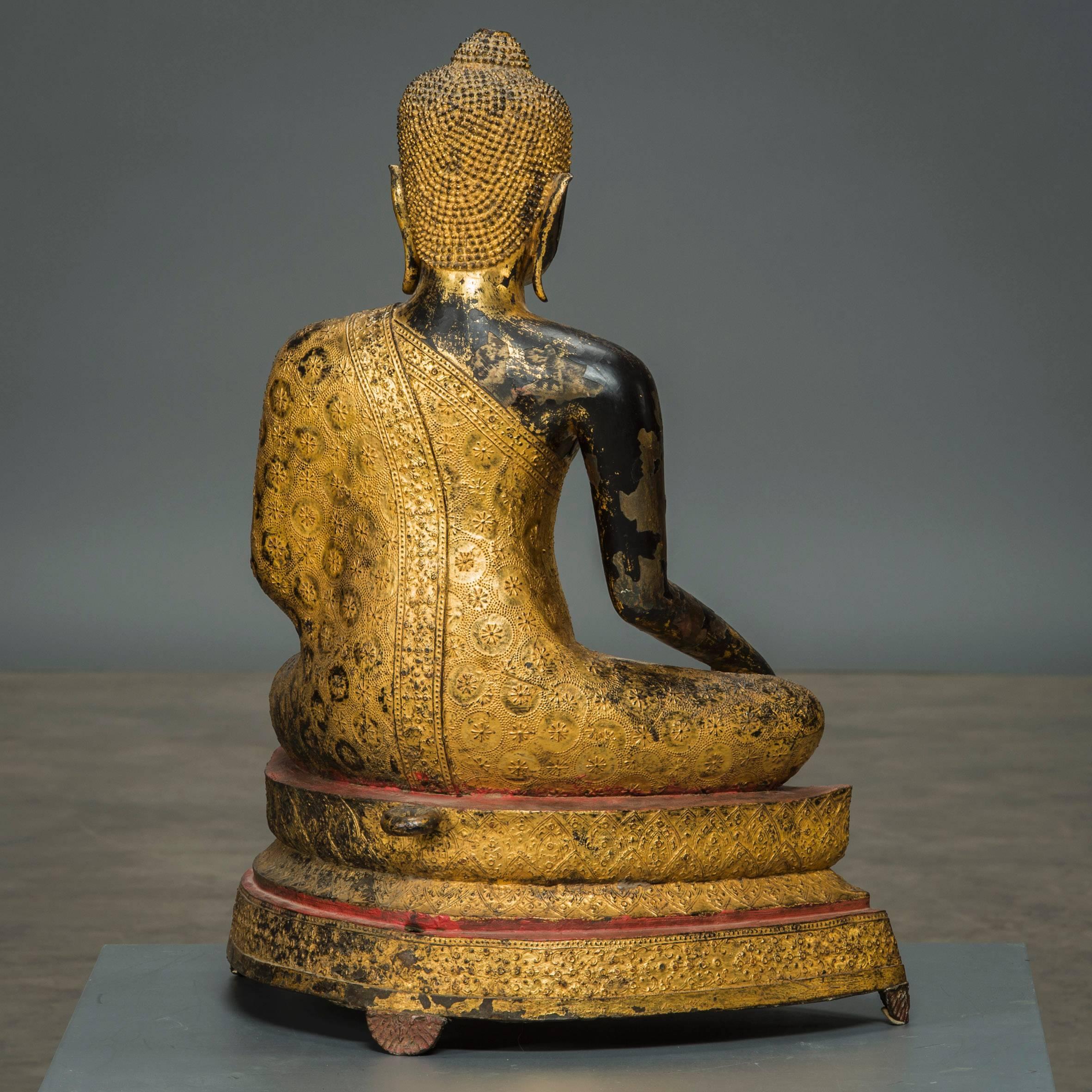 Bronze Buddha from Thailand (formerly Siam), 1800-1830, with original gilding, partially worn to black lacquer. Originally completely gilded with red lacquer edges.

The bronze imposed black lacquer, in order to get the gilding to stick. The wear