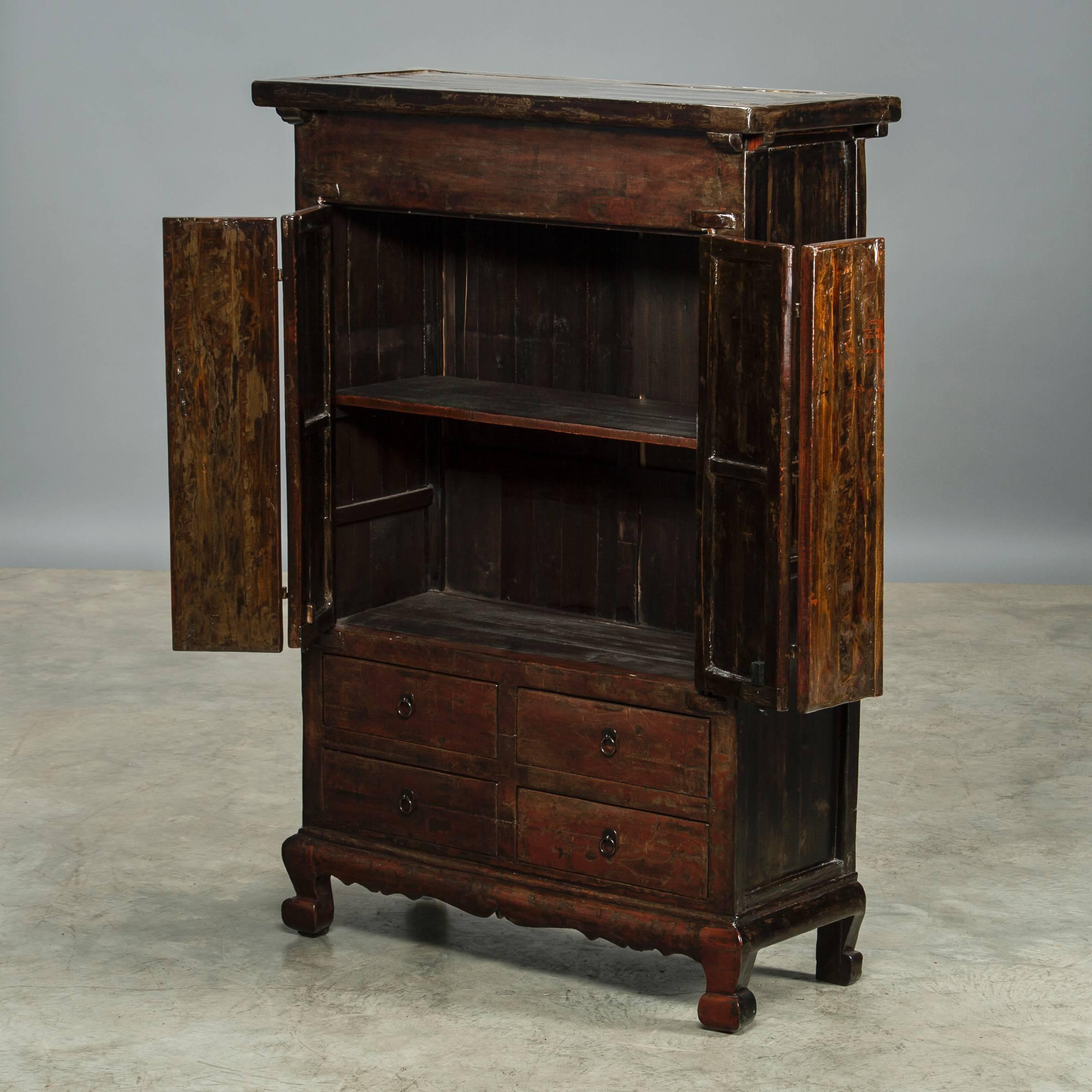 Cabinet from Shanxi with deep red lacquer front (thick lacquer) and black lacquer sides. A pair of doors and 4 drawers. The natural wear and tear on the thick lacquer gives the cabinet a fascinating charisma and patina, Shanxi, circa 1820.