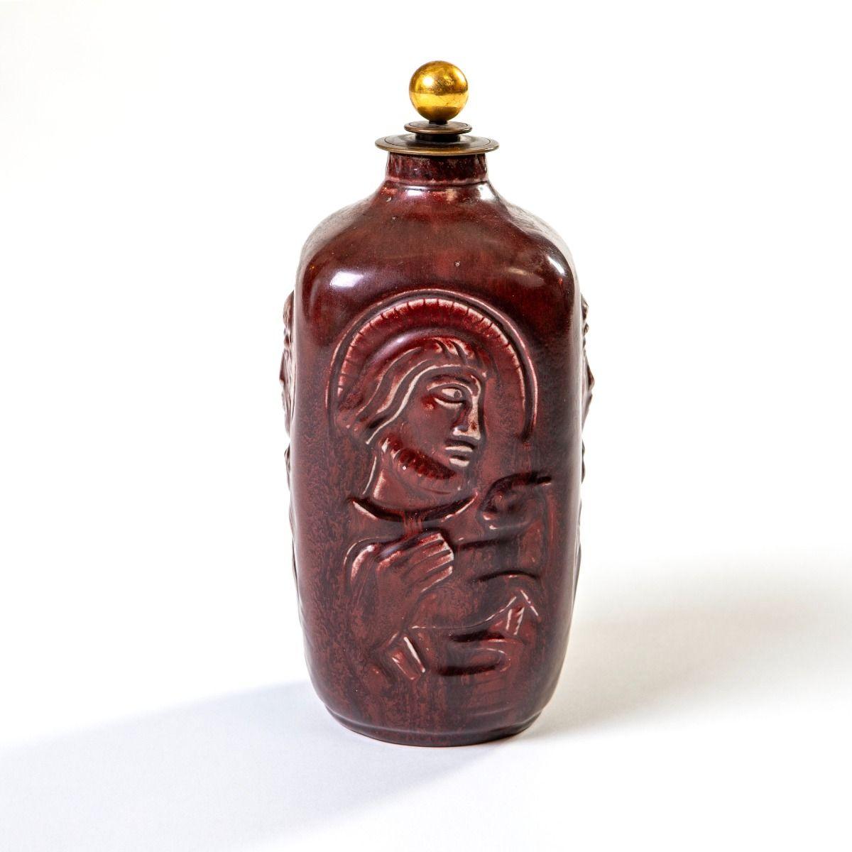 Jais Nielsen (1885–1961)
Lidded stoneware vase designed by Jais Nielsen and Knud Andersen for Royal Copenhagen, 1953.
The vase features a four-sided body with relief depictions of the Four Evangelists, finished in deep red oxblood glaze
