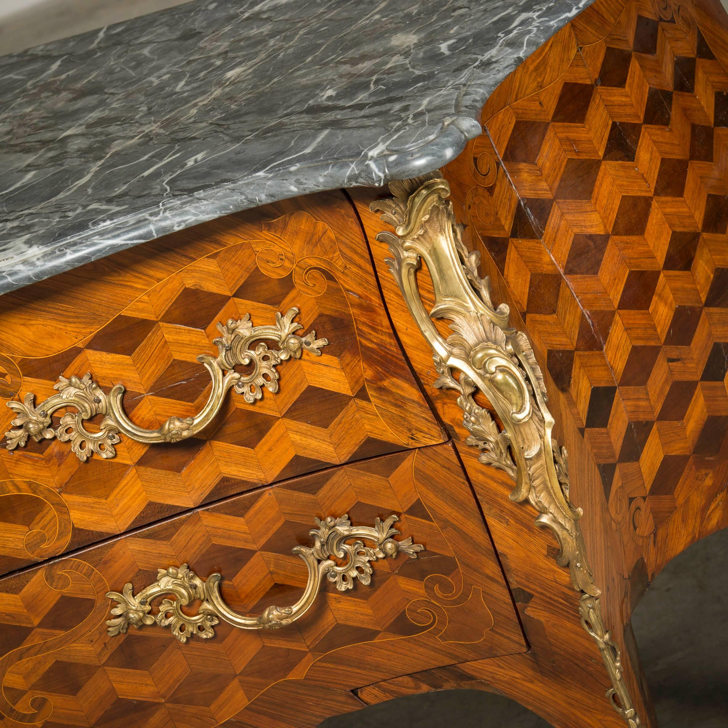 Large (148 cm wide) decorative Louis XV chest commode. 
Rosewood and mahogany parquetry, gilt bronze mounting.
Original grey Belgian marble-top with molded edge.
France, 1760-1770.

A beautiful and decorative chest of drawers.