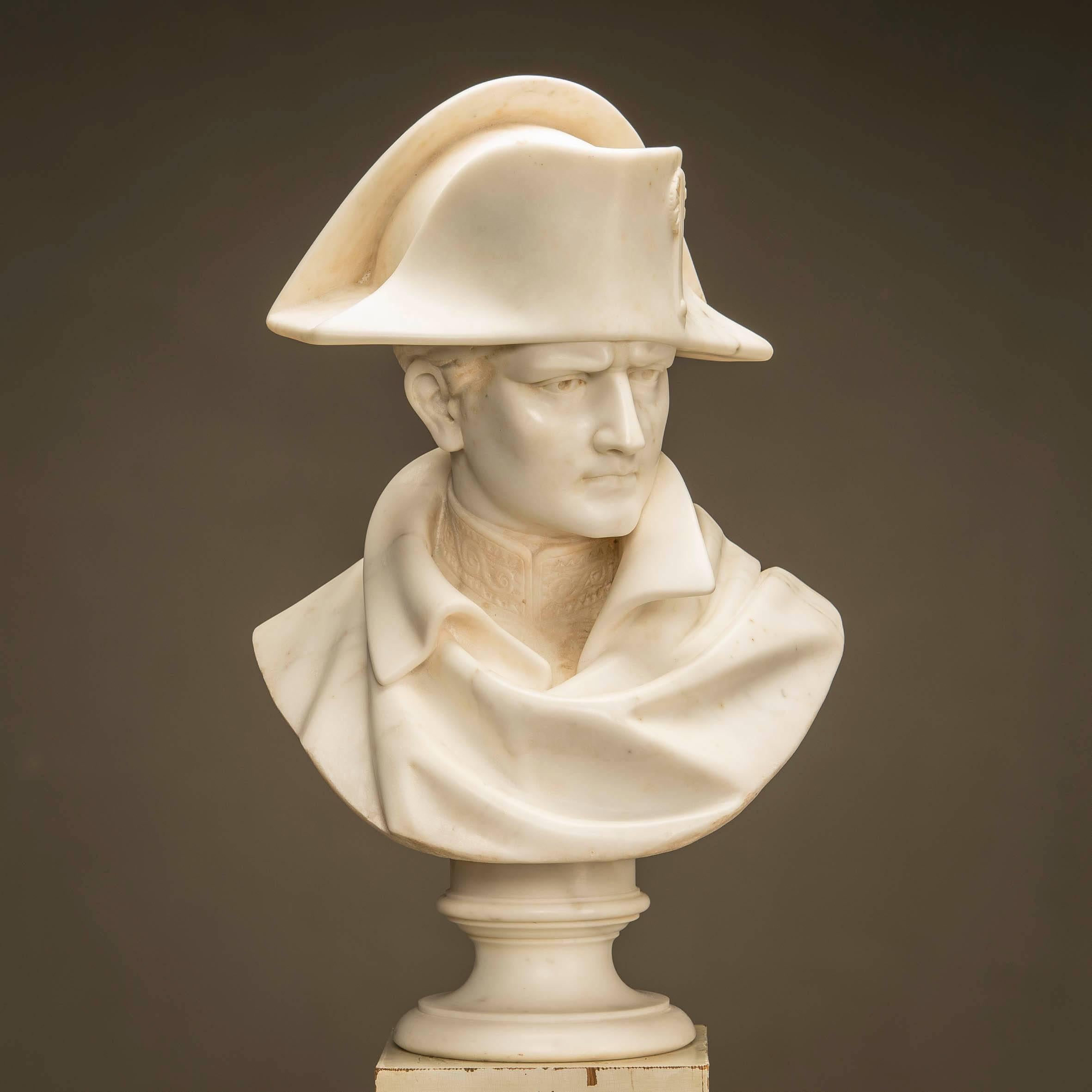 Bust of Napoleon made of white marble. 64 cm high. Signed: 'David'. Wood base (H 129, W 29, D 29) in the original white color with gilded woodcuts, among others 'N' for Napoleon. France 1840-1870.