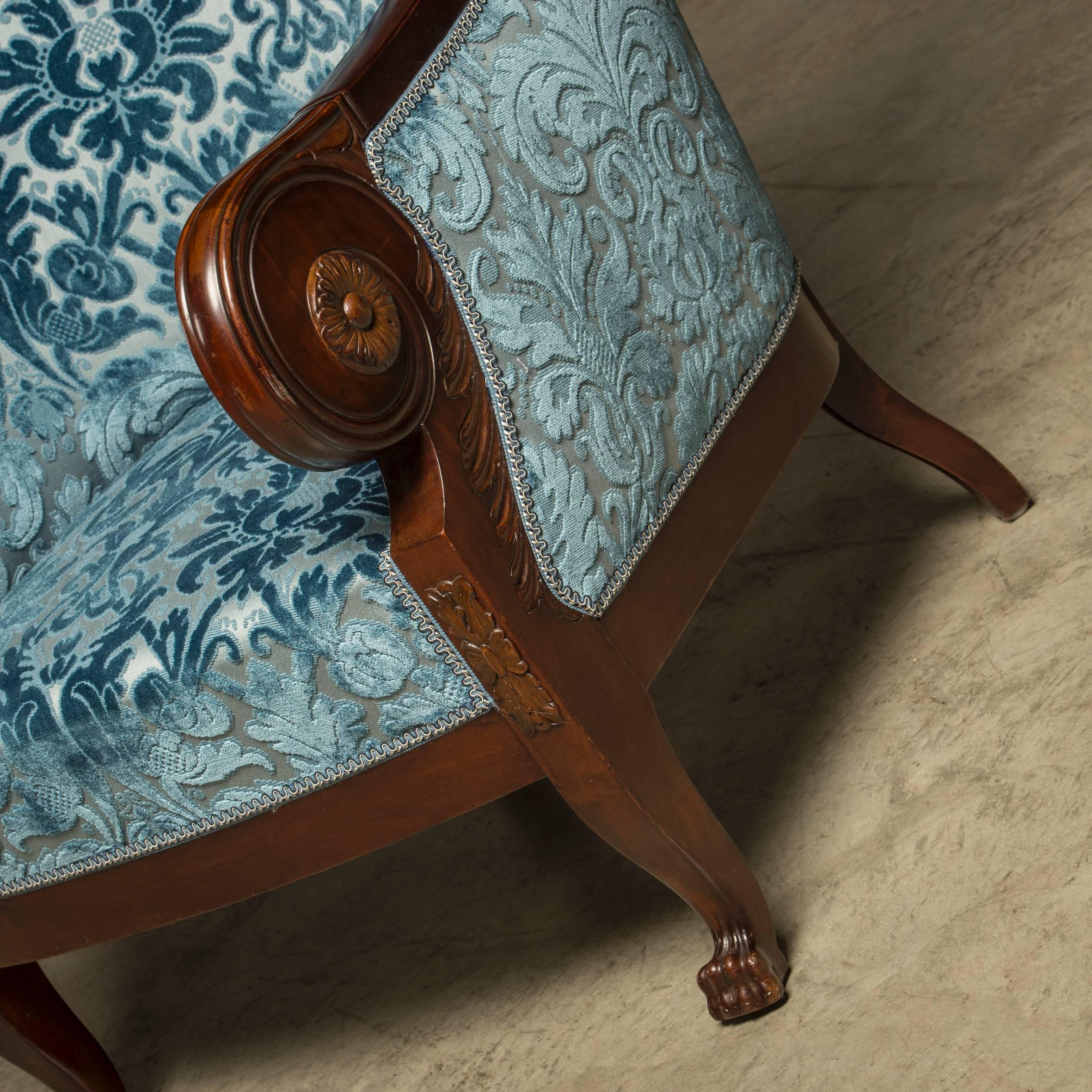 Pair of Art Deco armchairs in mahogany with legs ending in animal paws. Reupholstered with fabric from Lelievre. High quality craftsmanship. Comfortable sitting, Copenhagen, circa 1920.