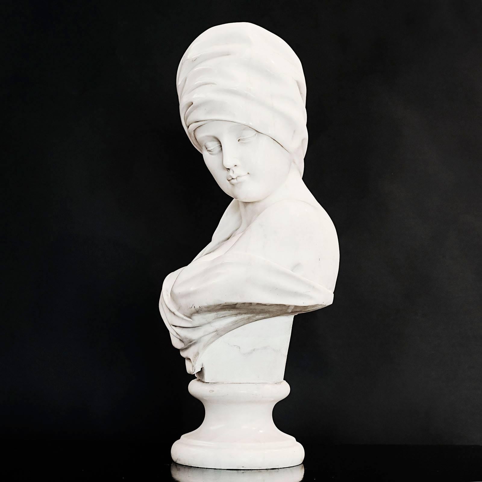 A finely carved Absolute marble carved bust of a women wearing a turban, raided on a turned pedestal, circa 1860s.