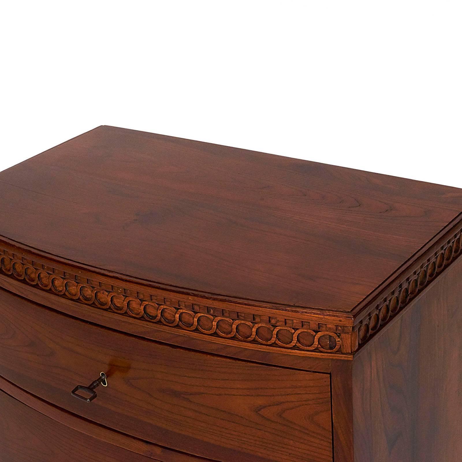 A Danish Louis XVI mahogany bow-front commode, circa 1790, the rectangular top with a bow front above a carved dentil and guilloché frieze, three long conforming drawers raised on bracket feet.