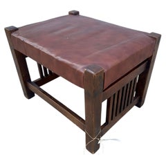 «Muebles artísticos con encanto»: reposapiés de roble con patas en forma de huso y tapizado de cuero rojo de la época de Stickley, modelo W7542