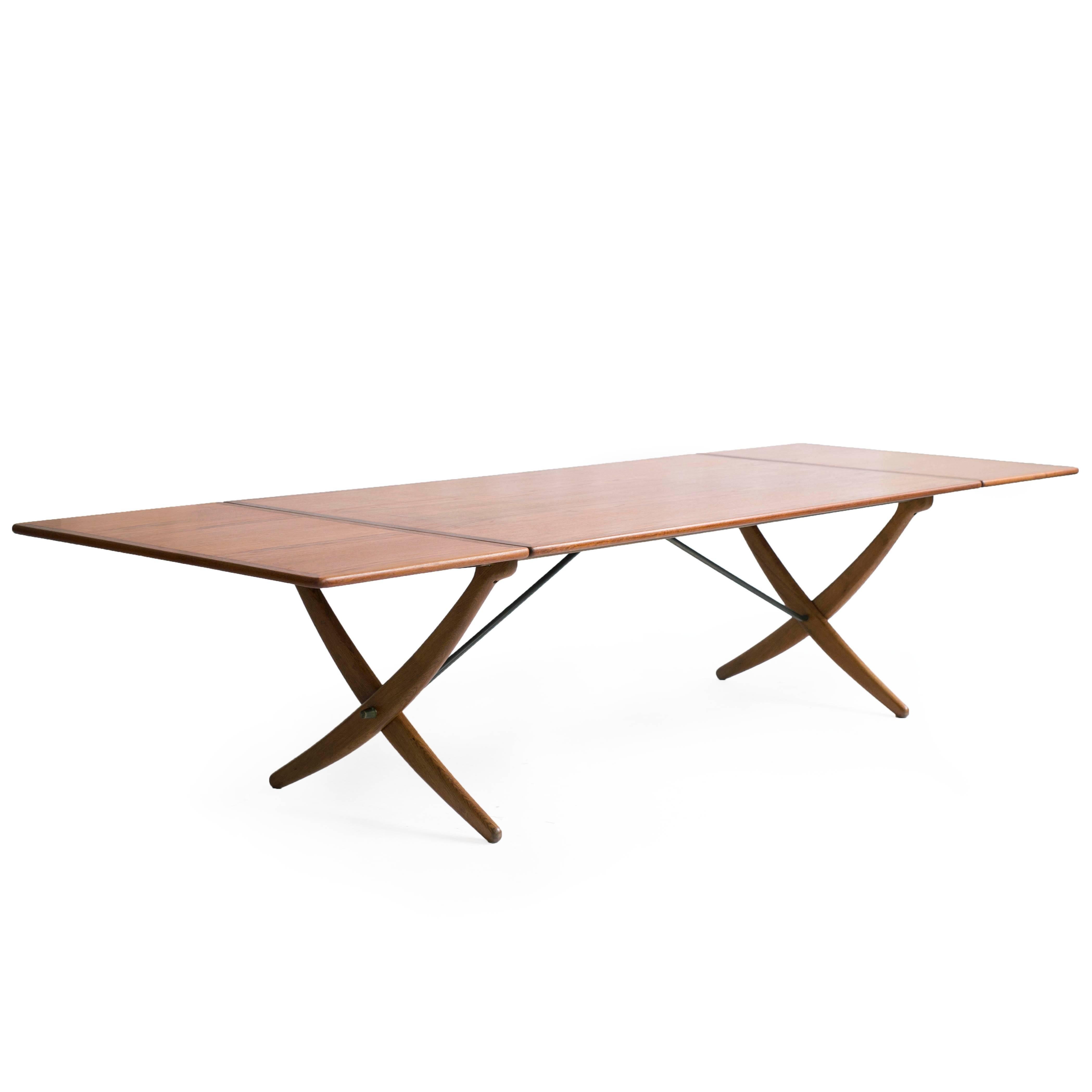 The large Hans J. Wegner sabre leg dining table with top and end leaves of teak, legs of oak.

Designed by Wegner, circa 1958 executed by cabinetmaker Andreas Tuck, model AT-314.

Measures: 190 cm to 310 cm width with both leaves up.
