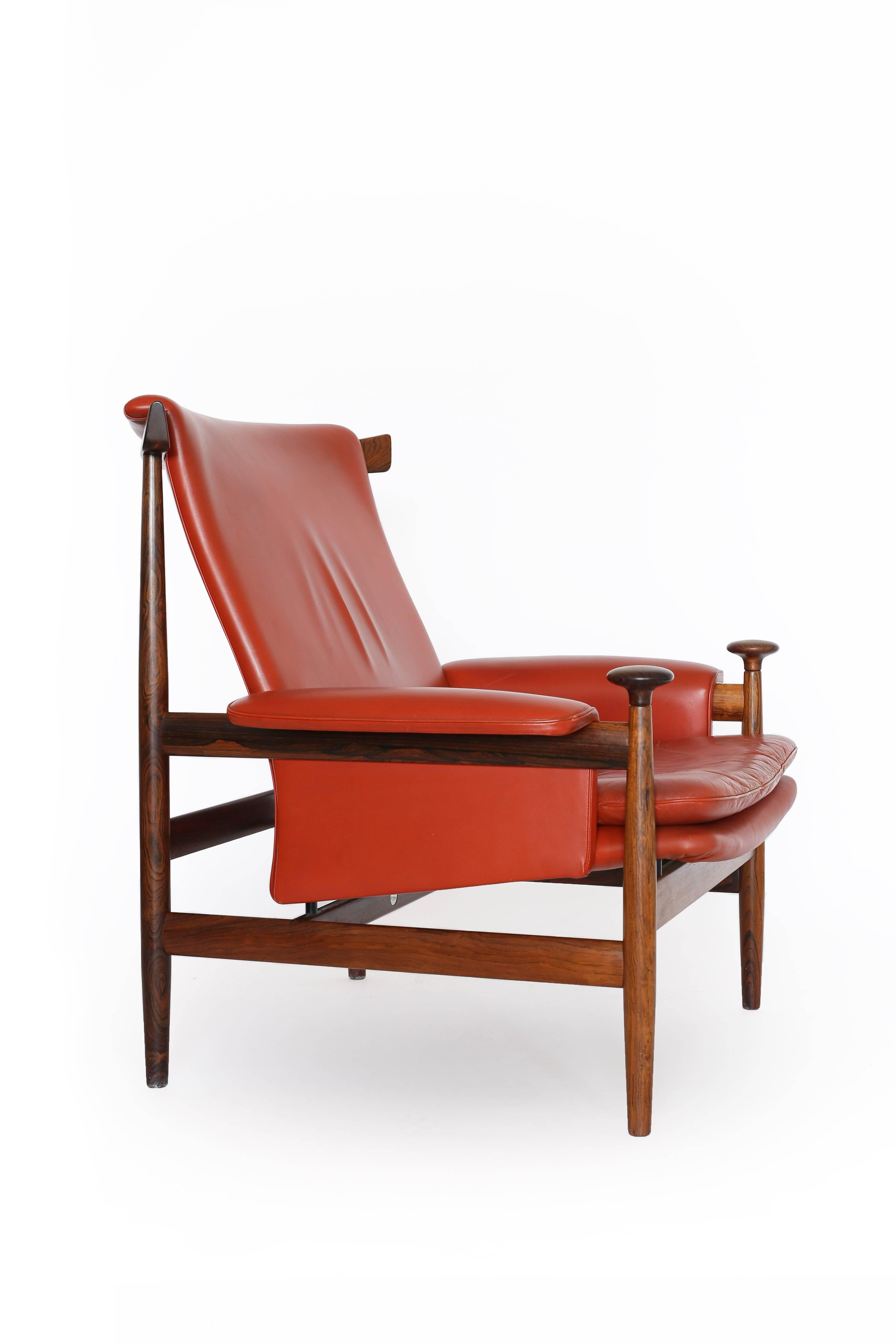Finn Juhl Bwana chair with frame of rosewood upholstered with original red leather. 

Designed by Juhl 1961 and made by France & Son, Denmark. 

Fine original condition.