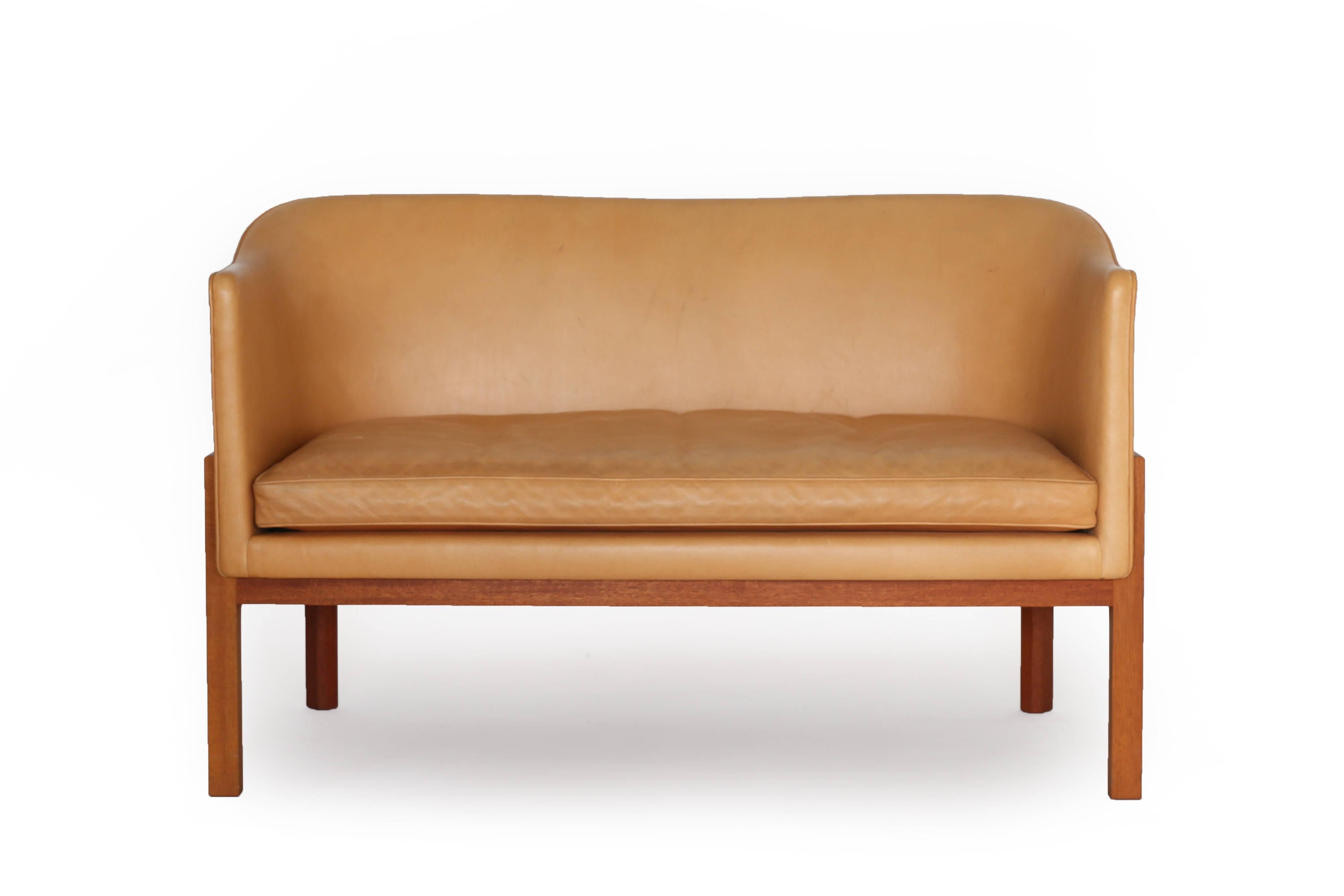 A little two-seat sofa with frame of mahogany upholstered with natural leather 

Designed by Mogens Koch in 1936 and made at cabinetmaker Rud. Rasmussen, Denmark.

 