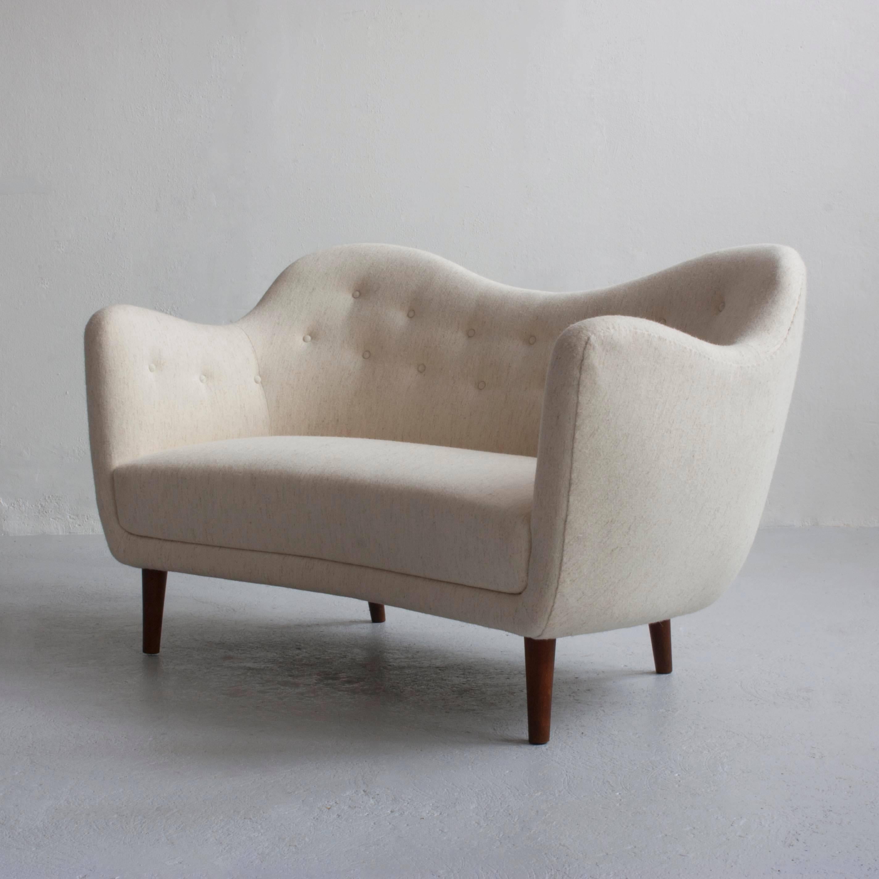 Finn Juhl two person BO46 sofa upholstered with off-white wool, tapering legs of stained beech. 

Designed by Finn Juhl, 1946 and manufactured by Bovirke, Denmark, 1948.