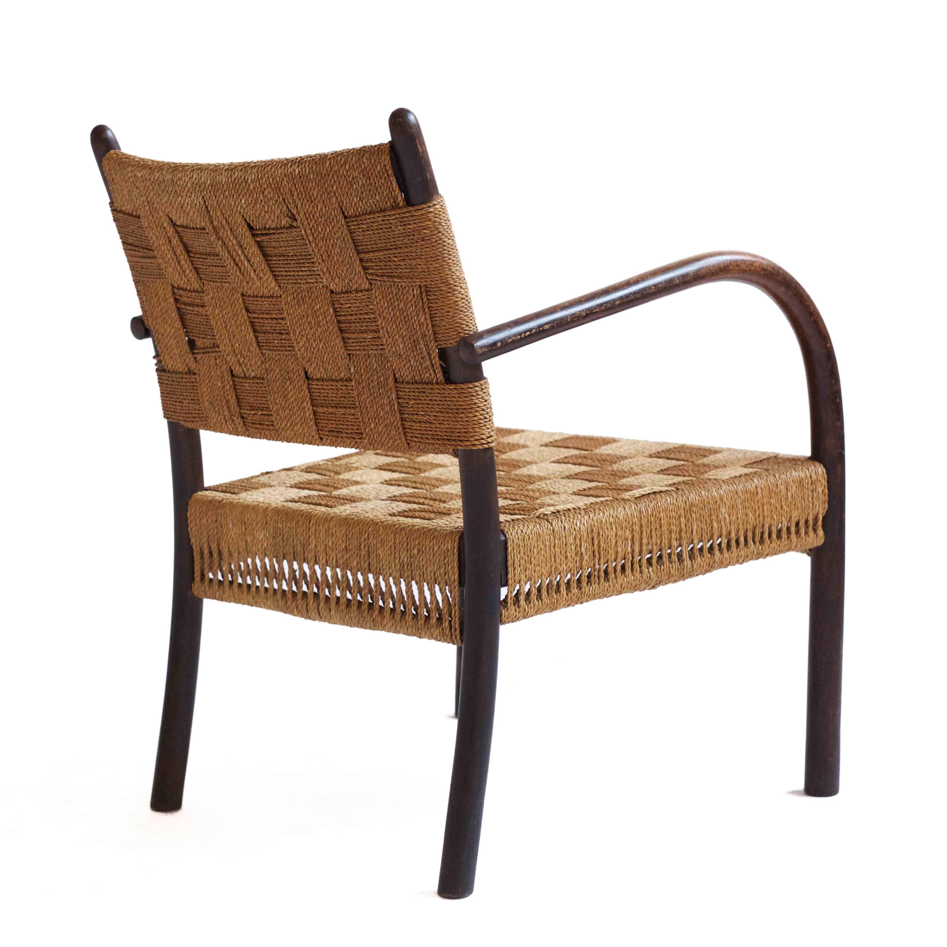 Frits Schlegel armchair with stained beech frame, seat and back upholstered with original woven sea grass. 

Designed by F. Schlegel 1935, manufactured by Fritz Hansen, Denmark, 1930s. 

Fine original condition.