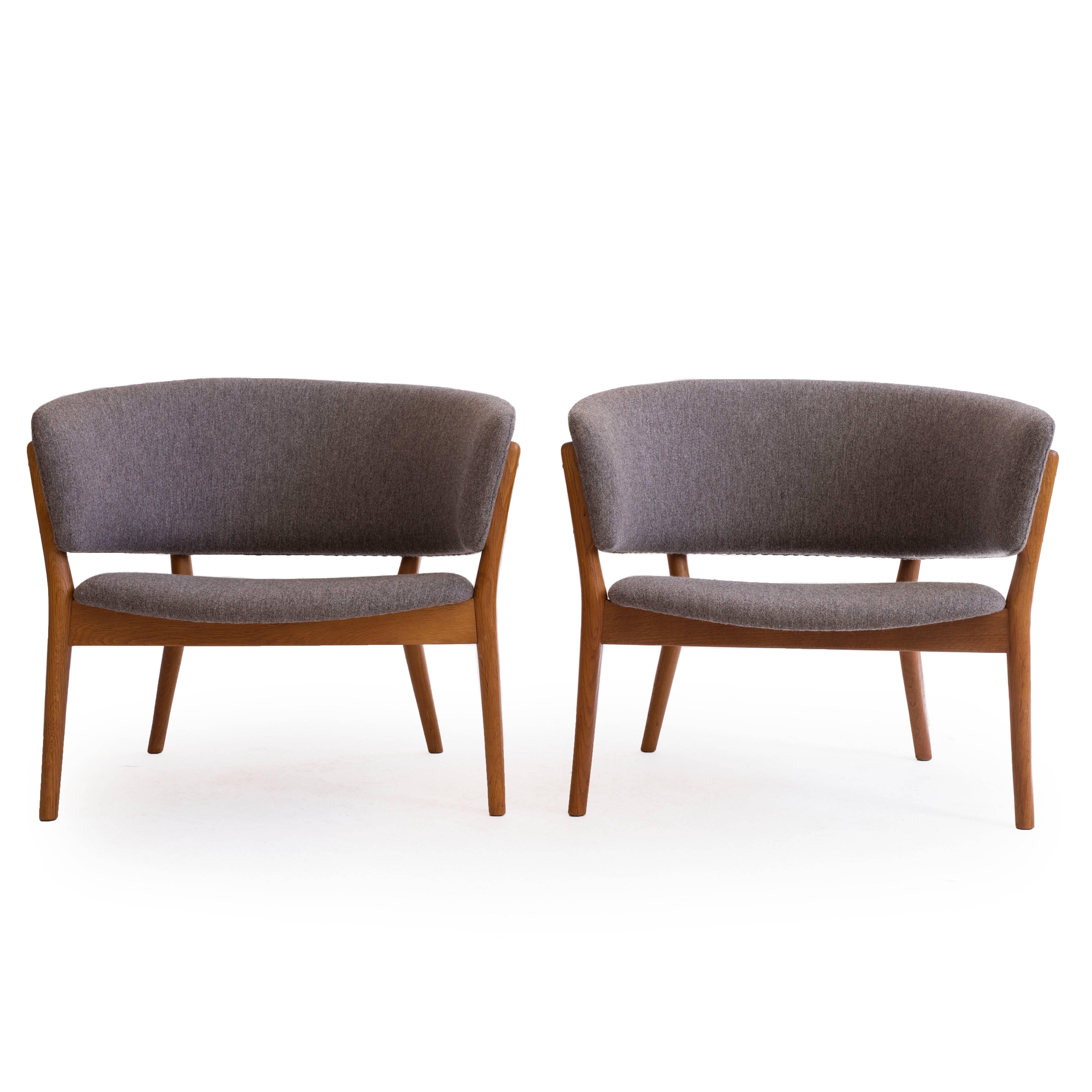 A pair of Nanna Ditzel oak easy chairs upholstered with grey wool fabric. 

Designed by Ditzel in 1952, manufactured by Søren Willadsen, Denmark model ND83.

Also available as single chair, please enquire.
 