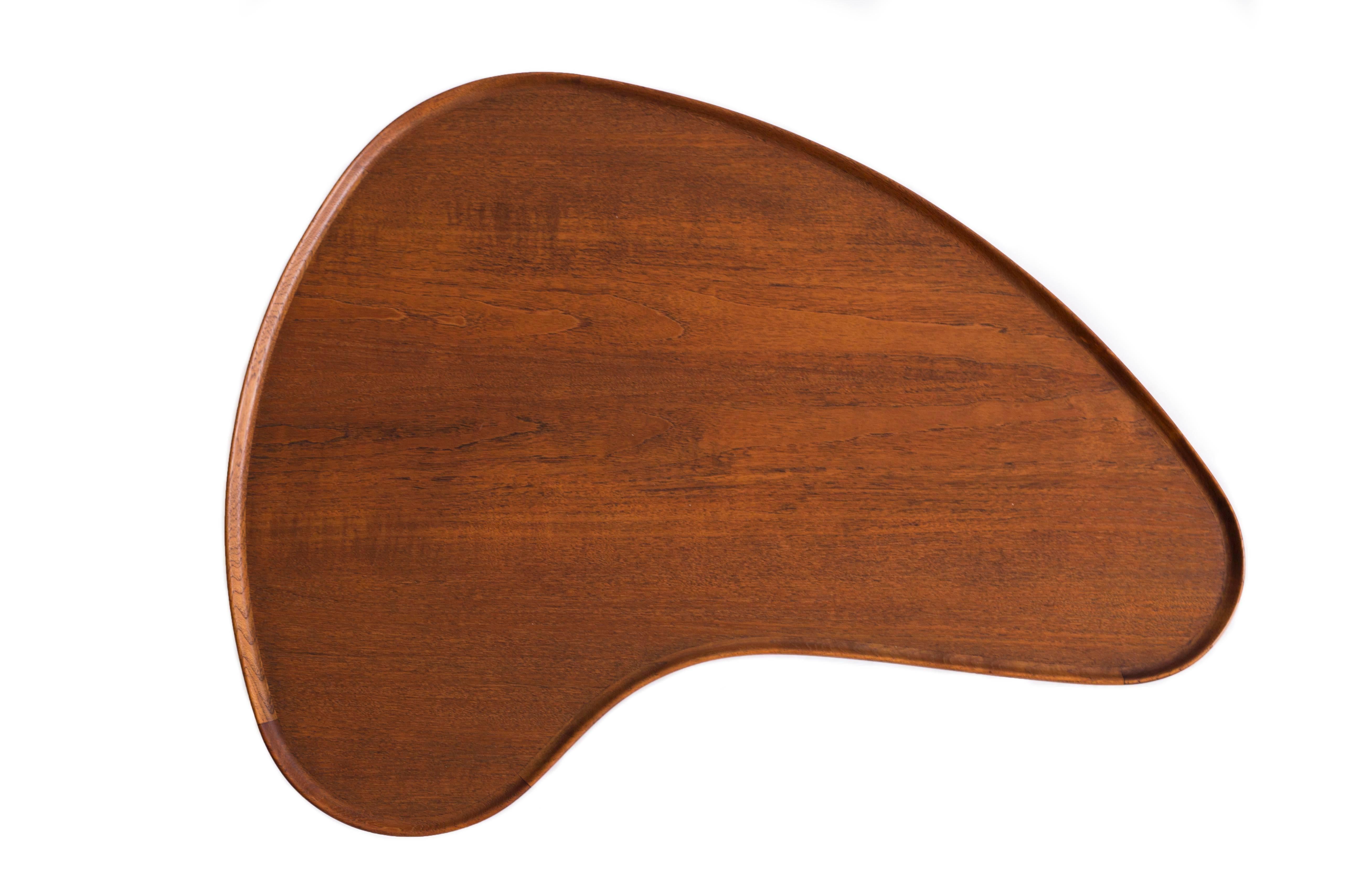 Arne Vodder kidney shaped coffee table with tabletop and shoes of teak, frame of patinated beech.

Designed by Arne Vodder in the 1950s and executed by Bovirke, Denmark.