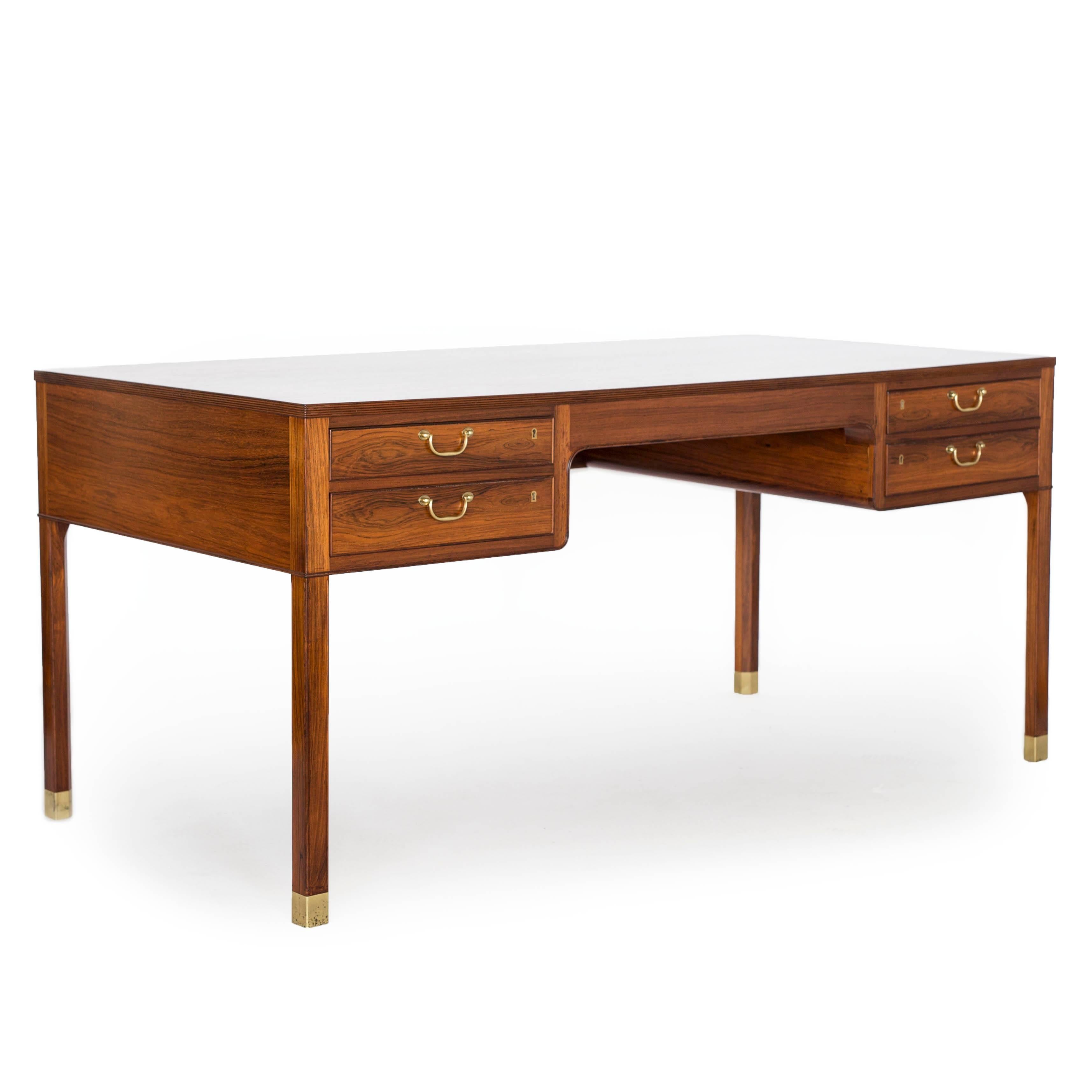 A freestanding Ole Wanscher Brazilian rosewood desk with brass fittings and profiled front. 

Designed 1950s, made by cabinetmaker A. J. Iversen, Denmark. 
Very fine condition.
