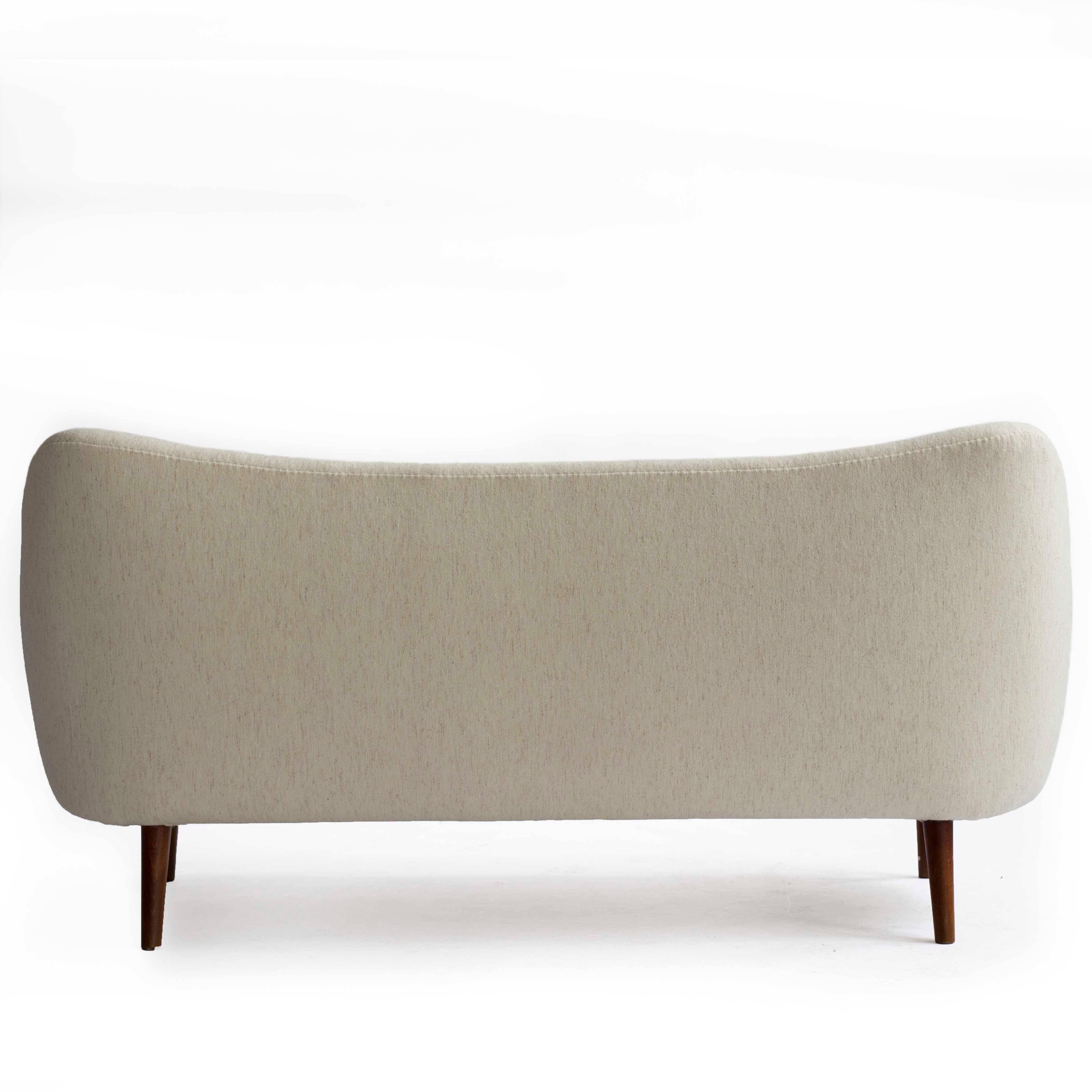 Finn Juhl 2.5 - 3 person sofa upholstered with off white wool, tapering legs of stained beech. 

Designed by Finn Juhl 1948 and manufactured by Bovirke Denmark, model BO64.
         