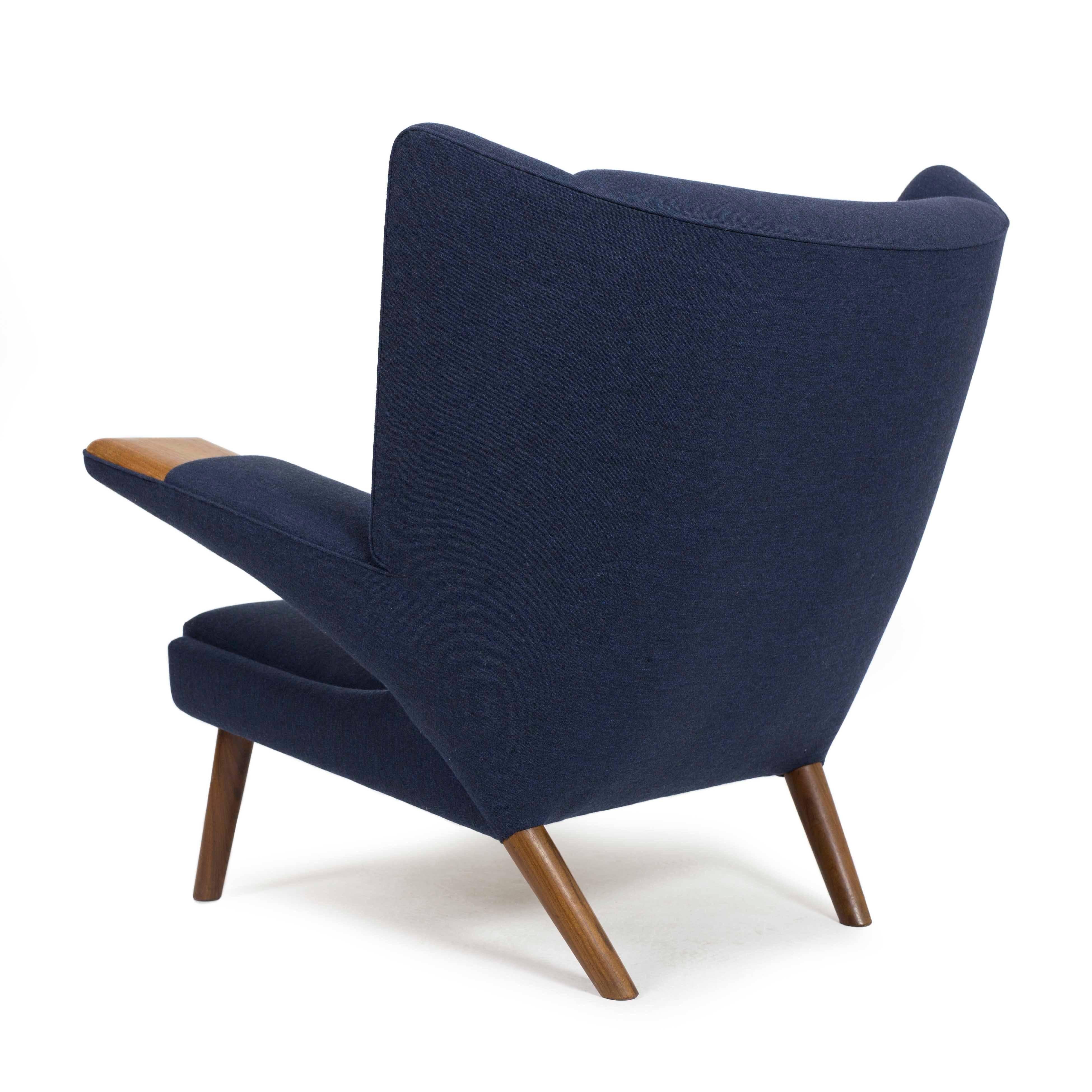 Hans J. Wegner mega bear chair with legs and exposed arms of teak. 
Blue fabric upholstery.
Designed by Hans J. Wegner, 1968, executed by AP Stolen, Denmark.

  