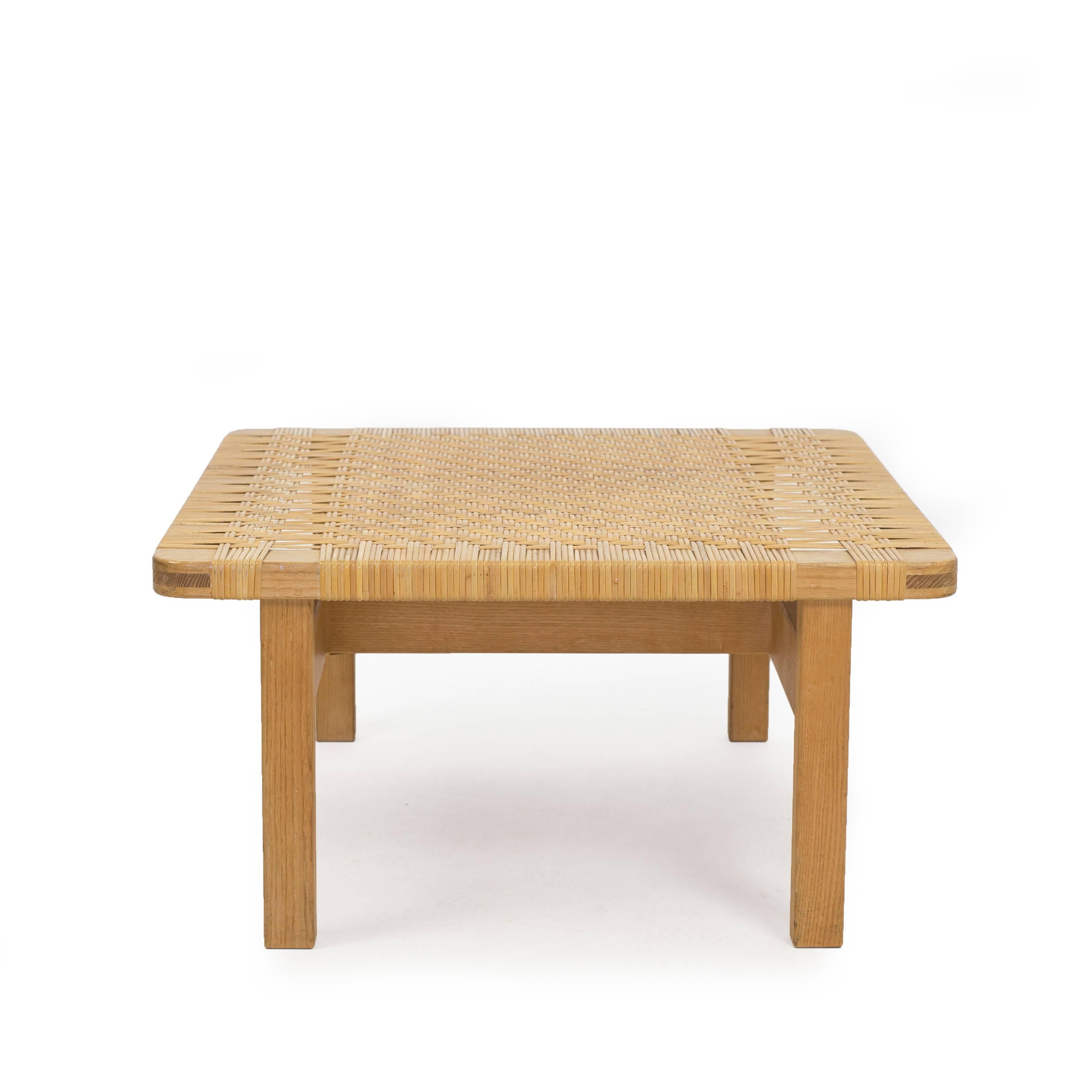 A square Børge Mogensen oak and woven cane bench. 
Designed 1950s and made at Fredericia Stolefabrik, model 5274
Measures: H 35 x W 69 x D 69 cm.

 