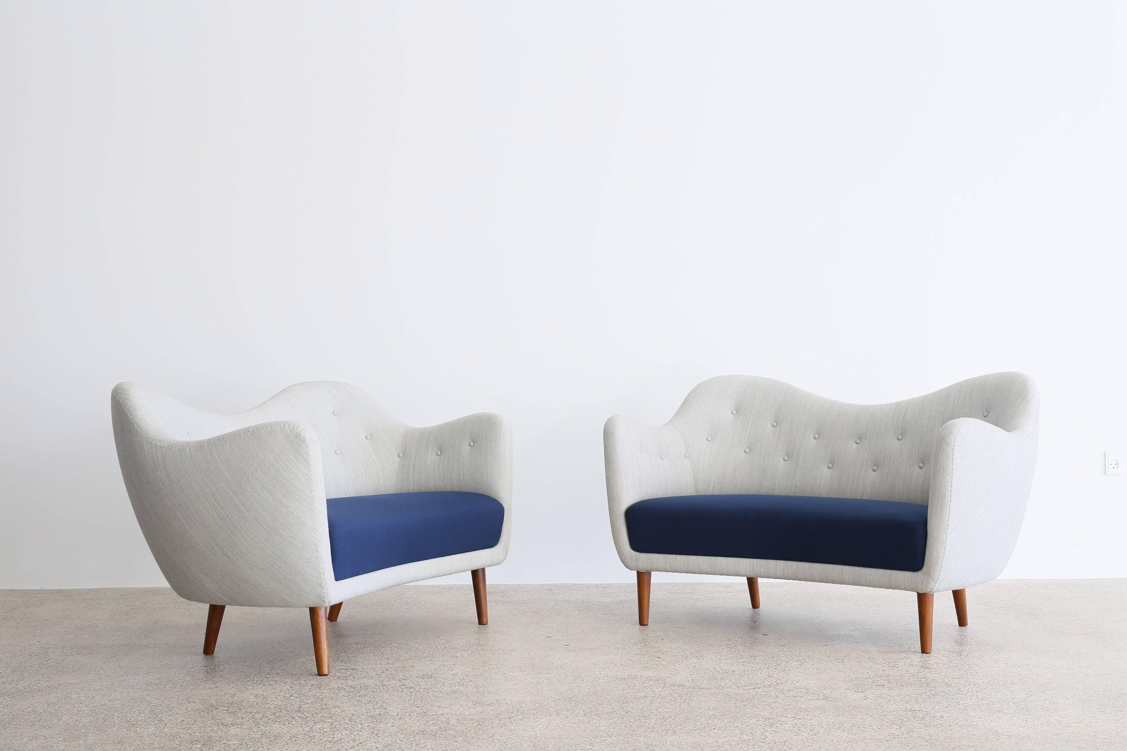 A pair of Finn Juhl sofas upholstered with fabric in grey and blue, tapering legs of stained wood. 
Designed by Finn Juhl, 1946 and manufactured by Bovirke, Denmark, model BO46.

Available as a pair, sold and priced individually. 

For additional