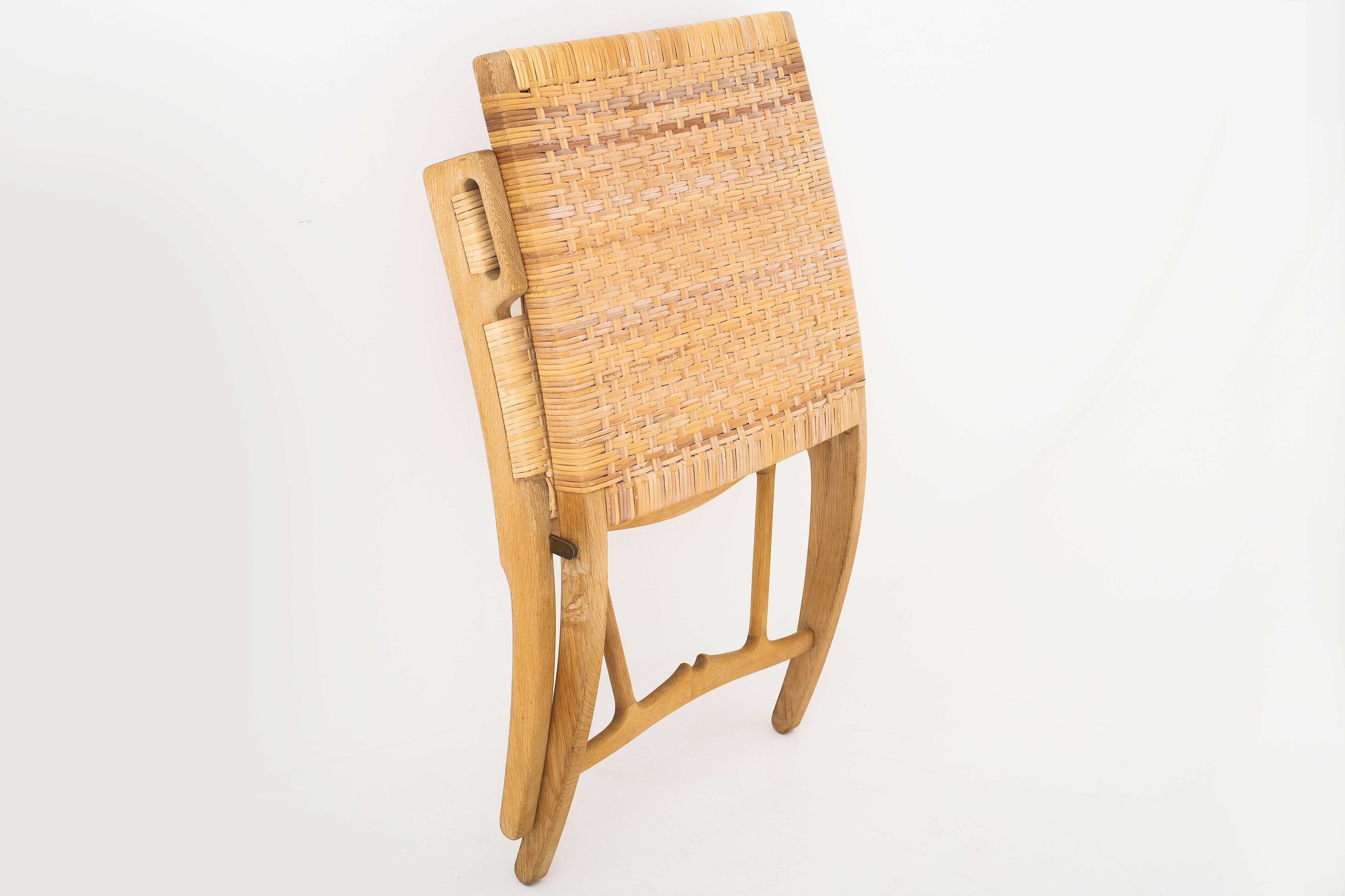 Original folding chair with frame in patinated oak. Seat and back in woven cane. Model JH 512. Designed in 1949. Produced by cabinet maker Johannes Hansen.
                          