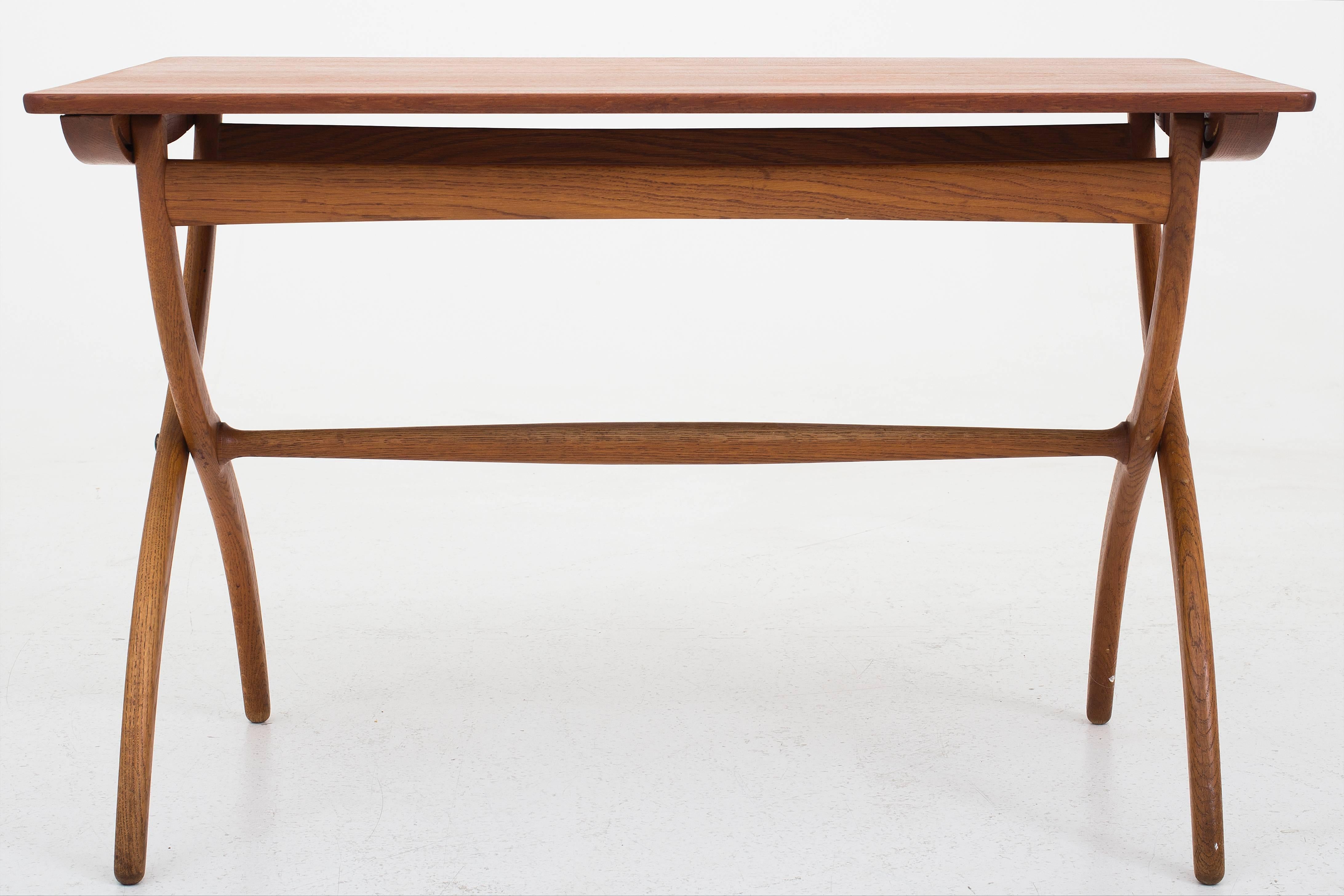 Folding coffee table with teak top and curved oak legs. Produced by Rud Rasmussen, Denmark.