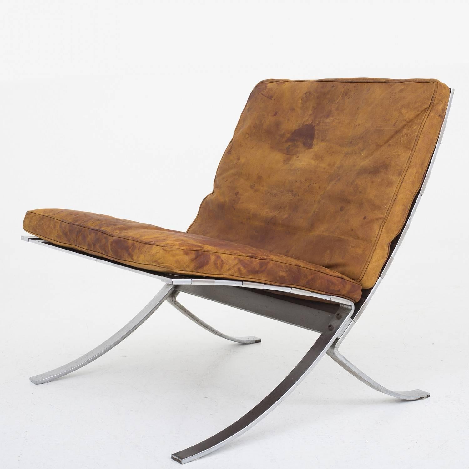 Lounge chair and stool in steel and patinated leather. Model "tango" Designed by Steen Ostergaard. Maker Terrex Art. The stool is very rare.