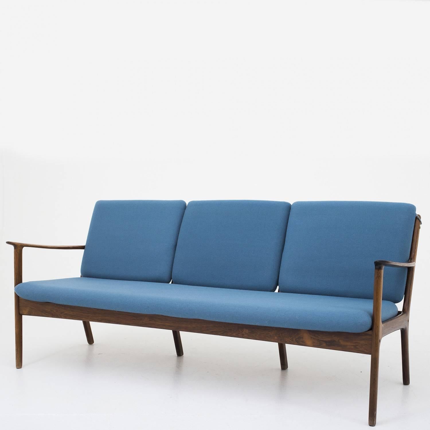 PJ 112 three-seat sofa in rosewood and original wool cushions. Designed by Ole Wancher. Maker P.J. Furniture.