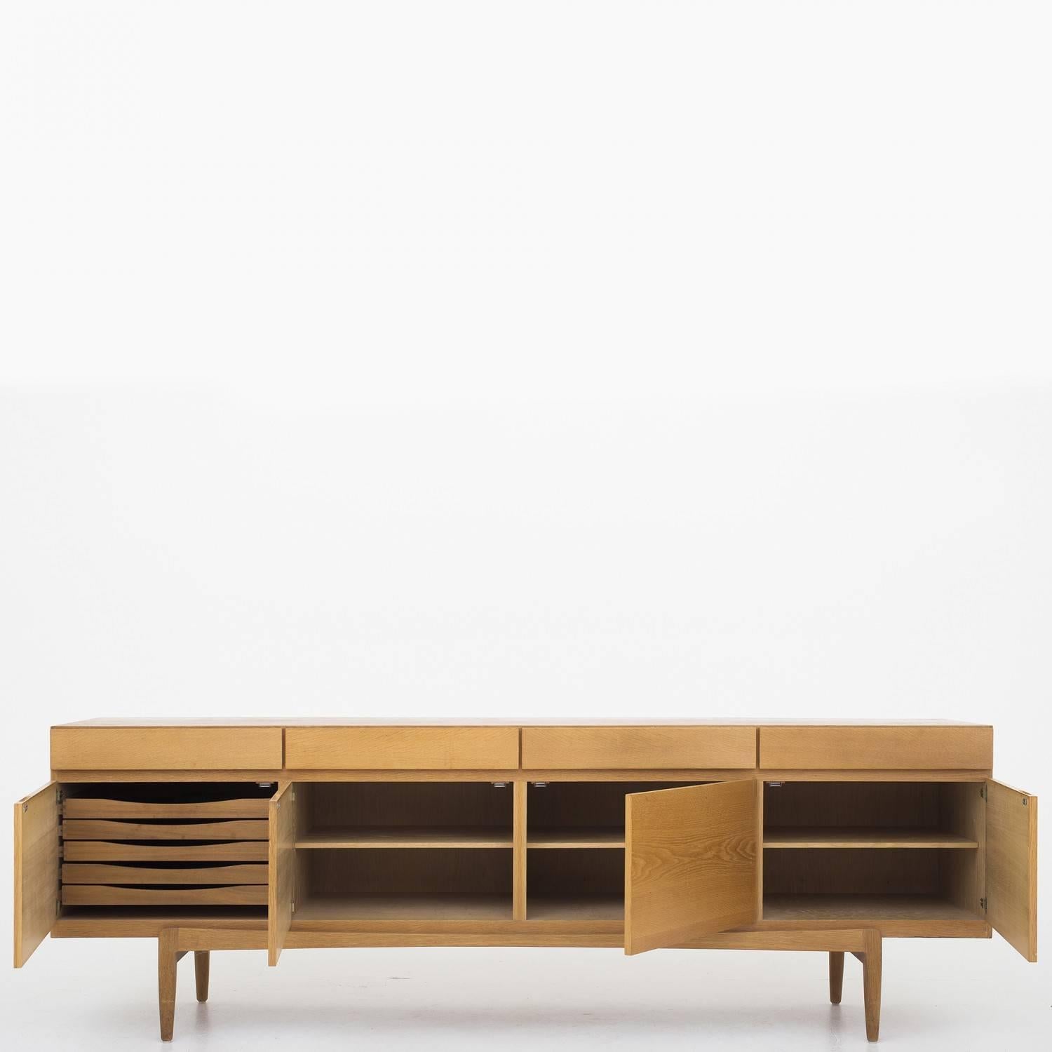 Sideboard in oak, front with four drawers. designed by Ib Kofod-Larsen. Maker Faarup Møbelfabrik.