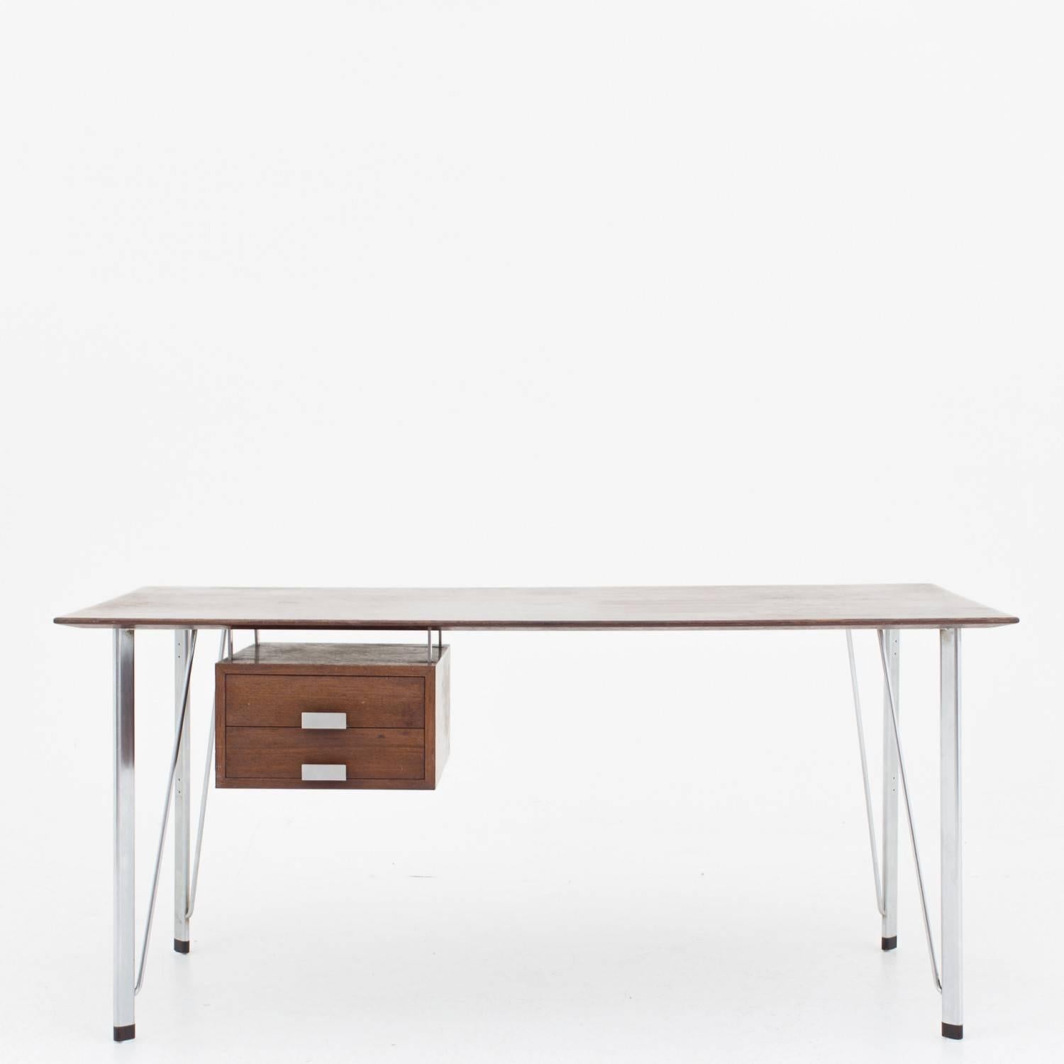 Desk in wenge and steel, two front drawers with handles in metal. Designed by Arne Jacobsen. Maker Fritz Hansen.