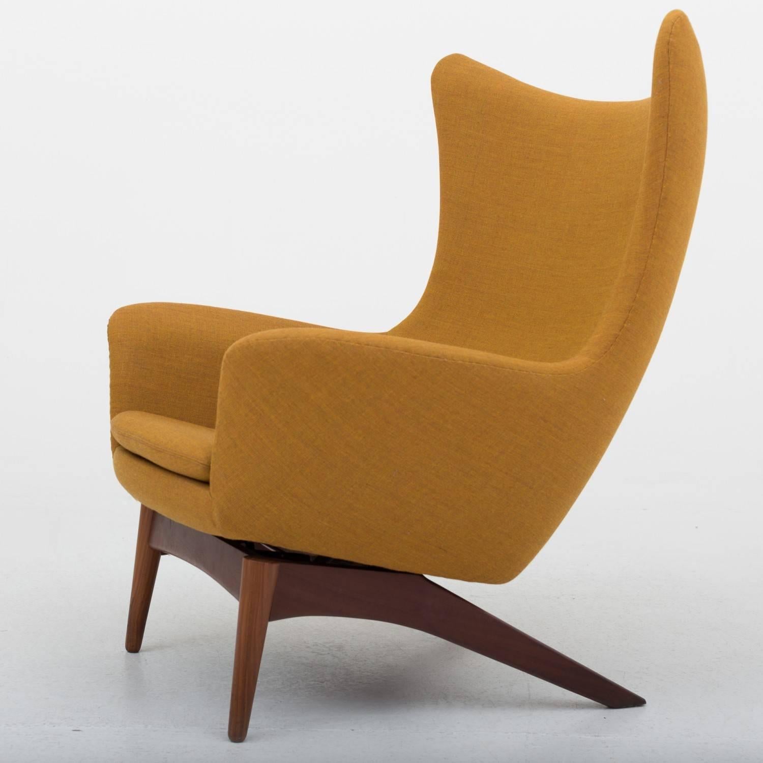 Easy chair and stool in teak. Reupholstered in wool (Canvas 424) model 207. Chair with tilt function. Designed by H.W. Klein and maker Bramin.