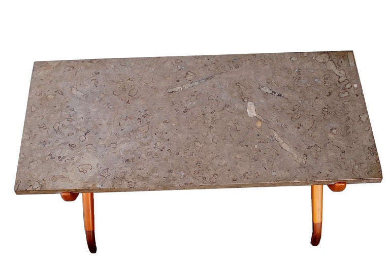A rare beech and mahogany coffee table with a Porsgrunn marble top with many fossils.
Made by Nordiska Kompagniet, 1950s.