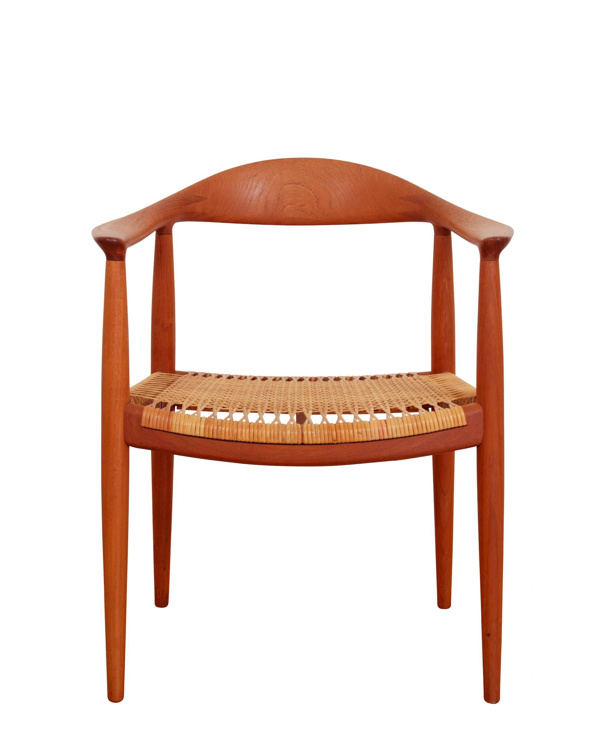 Teak chair with woven cane seat. Manufactured by Johannes Hansen.