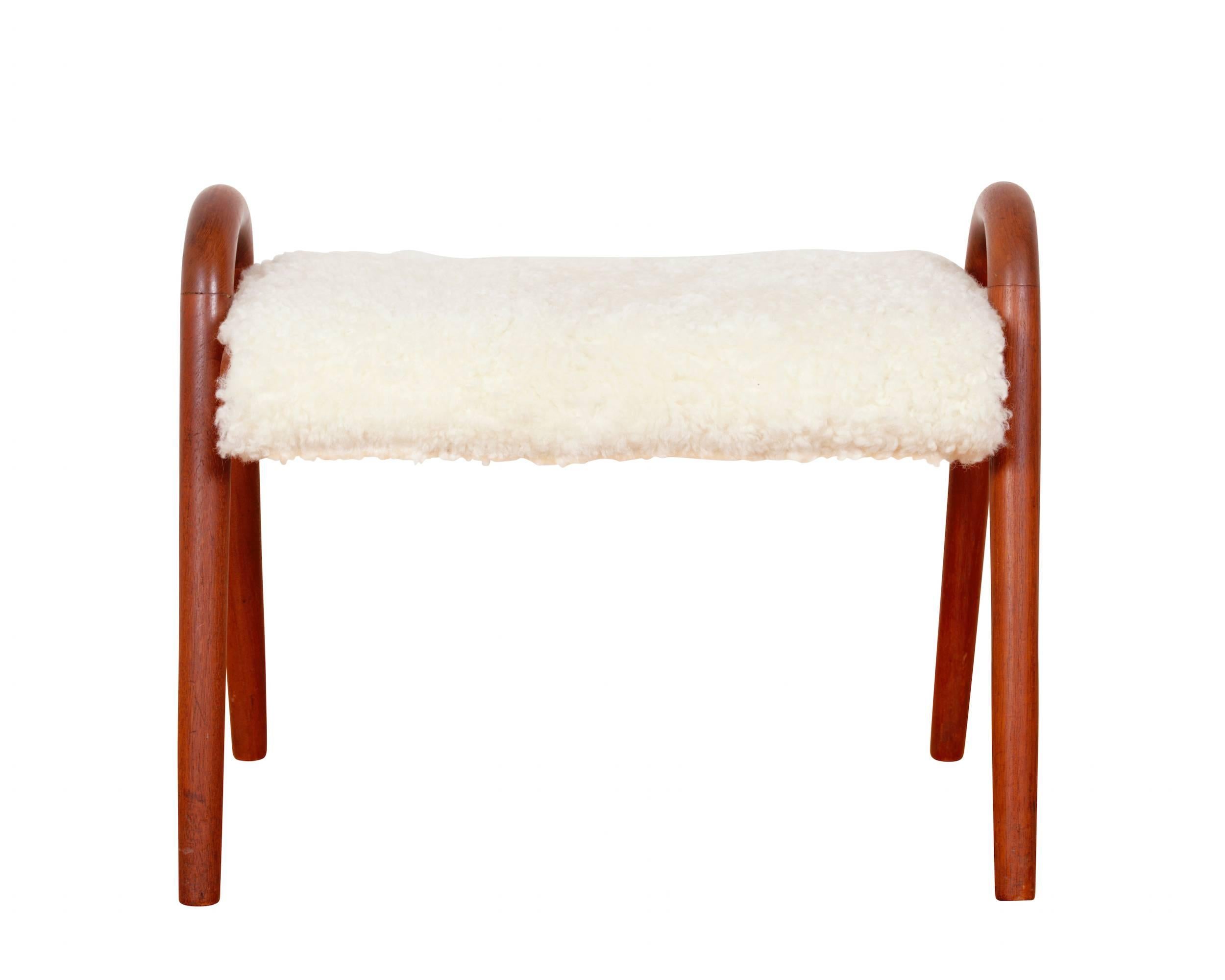A pair of teak stools, upholstered with sheepskin.
Manufactured by Rud Rasmussen.